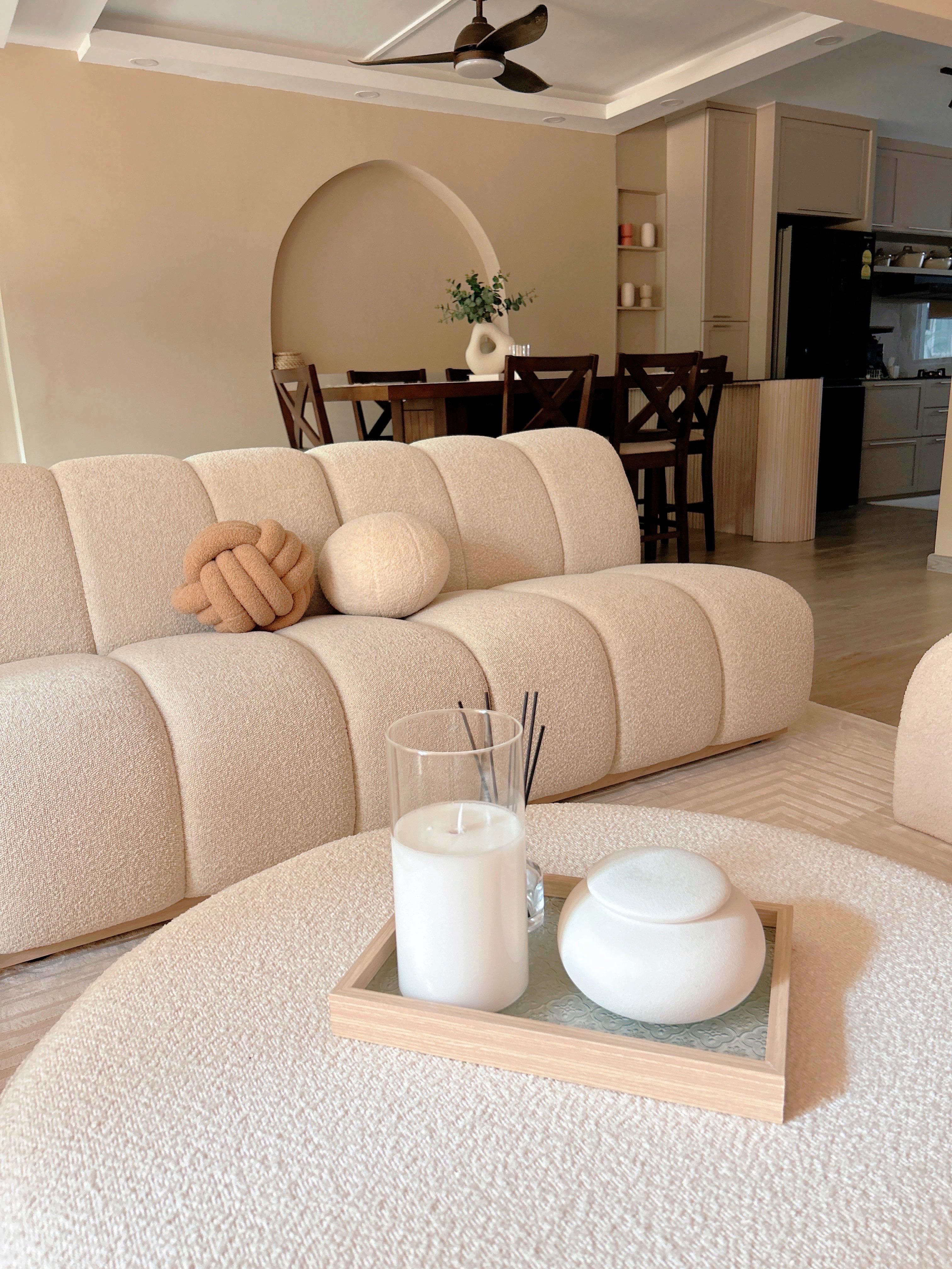 Creating Comfort: Our Personalized Home Decor - Cream-colored sofa, beige cushions, soft lighting, modern decor, cozy