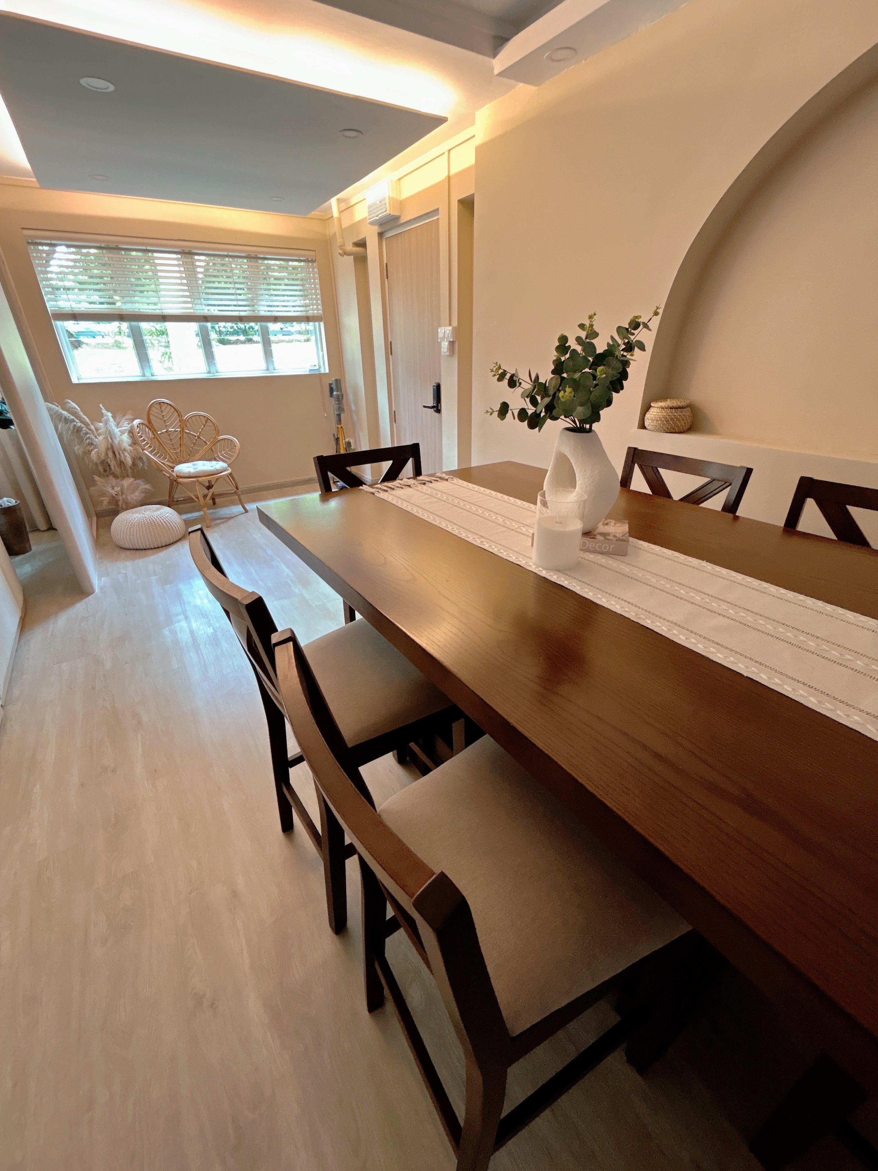 Creating Comfort: Our Personalized Home Decor - Modern dining room with wooden table and chairs, beige walls, large window