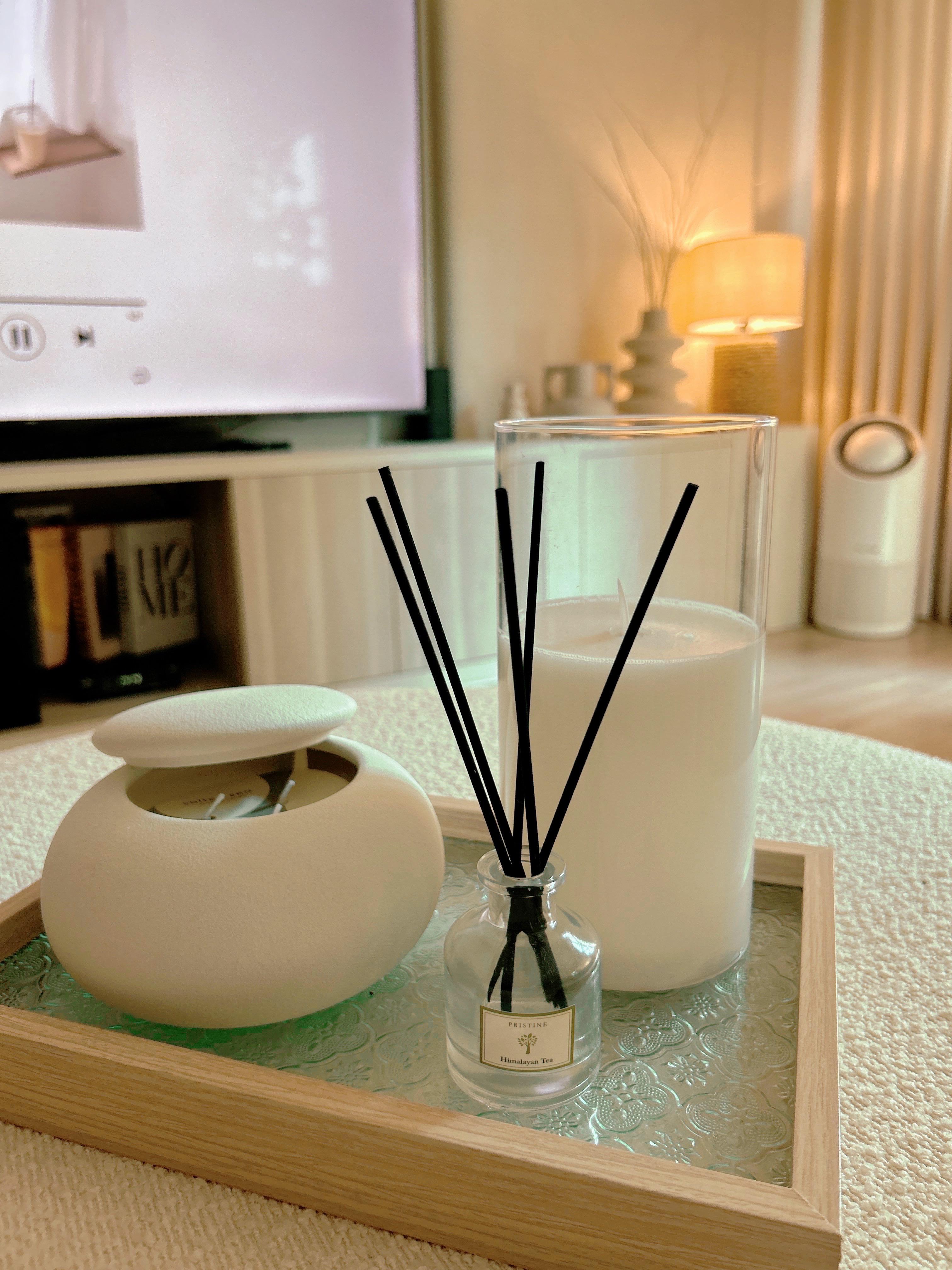 Creating Comfort: Our Personalized Home Decor - White candle, candle holder, candle flame, soft lighting, modern decor