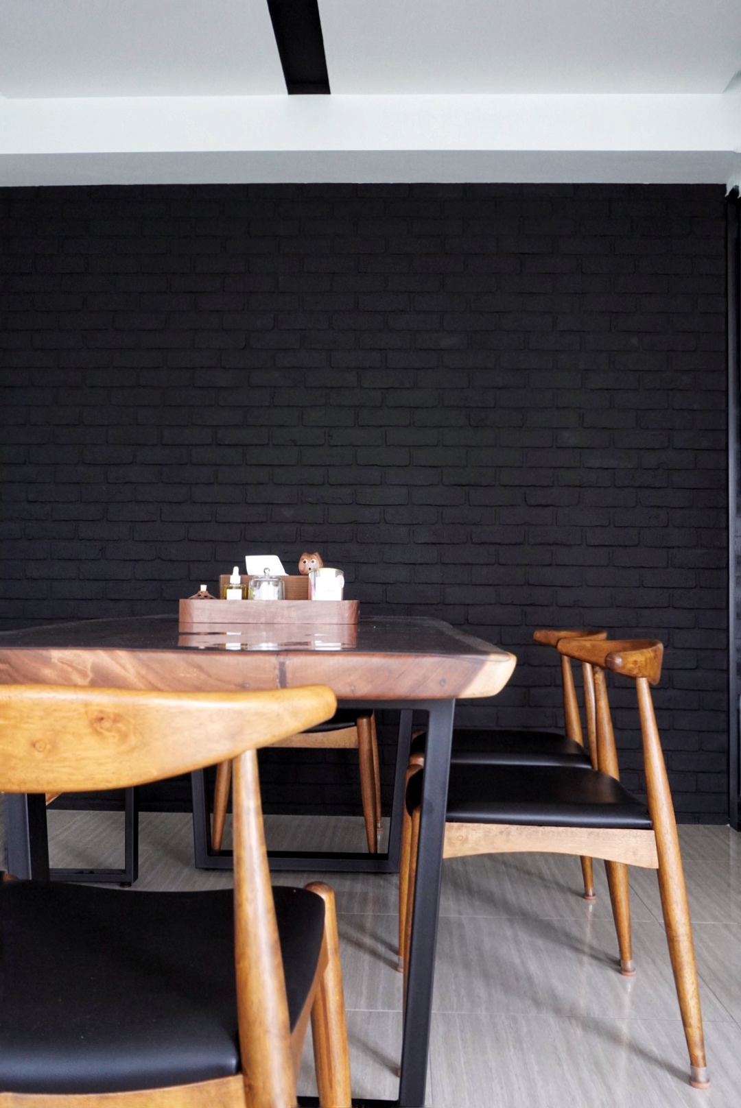 The Social Hub: Creating a space about connection and conversation - Wooden dining table, black brick wall, modern dining
