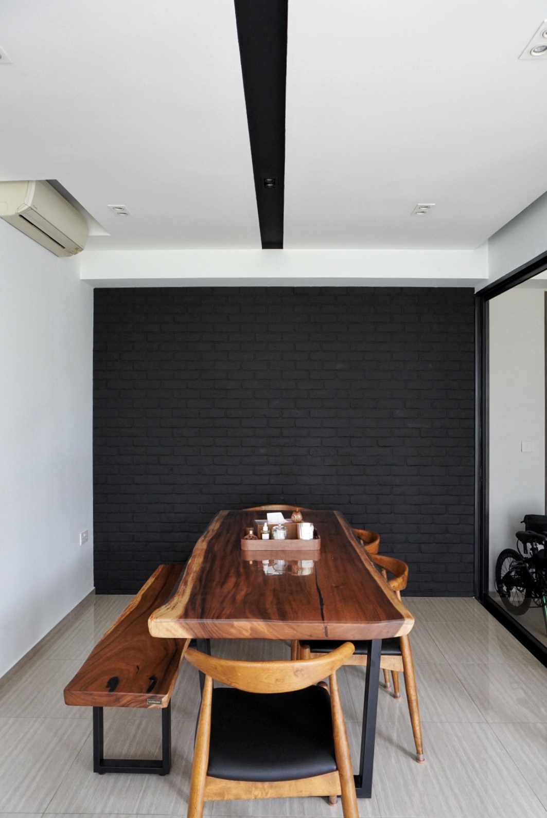 The Social Hub: Creating a space about connection and conversation - Wooden dining table, black brick wall, minimalist