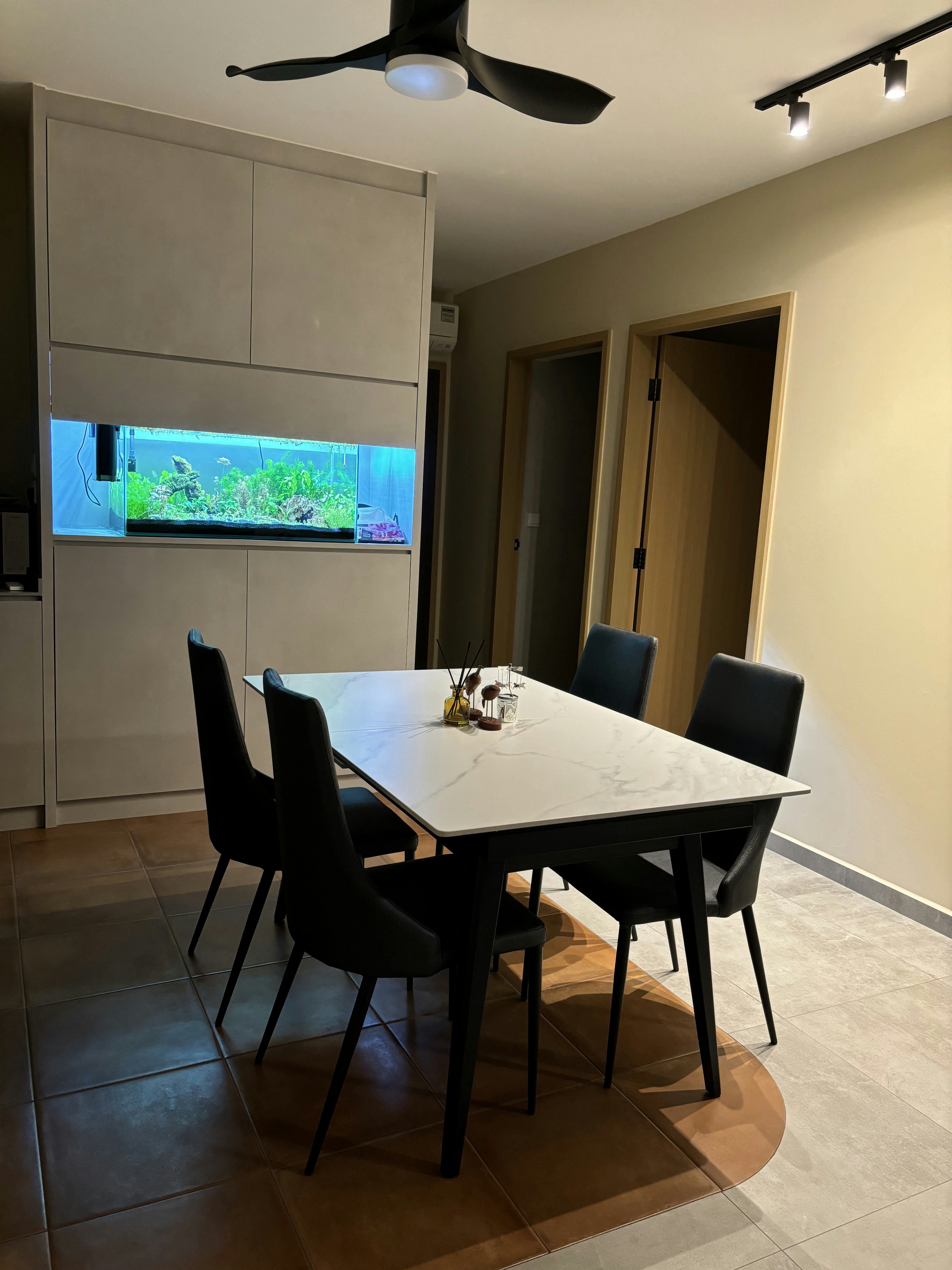 Our Dining Space: Where everything happens (even a fish tank!) - Modern dining room with sleek black chairs, minimalist white