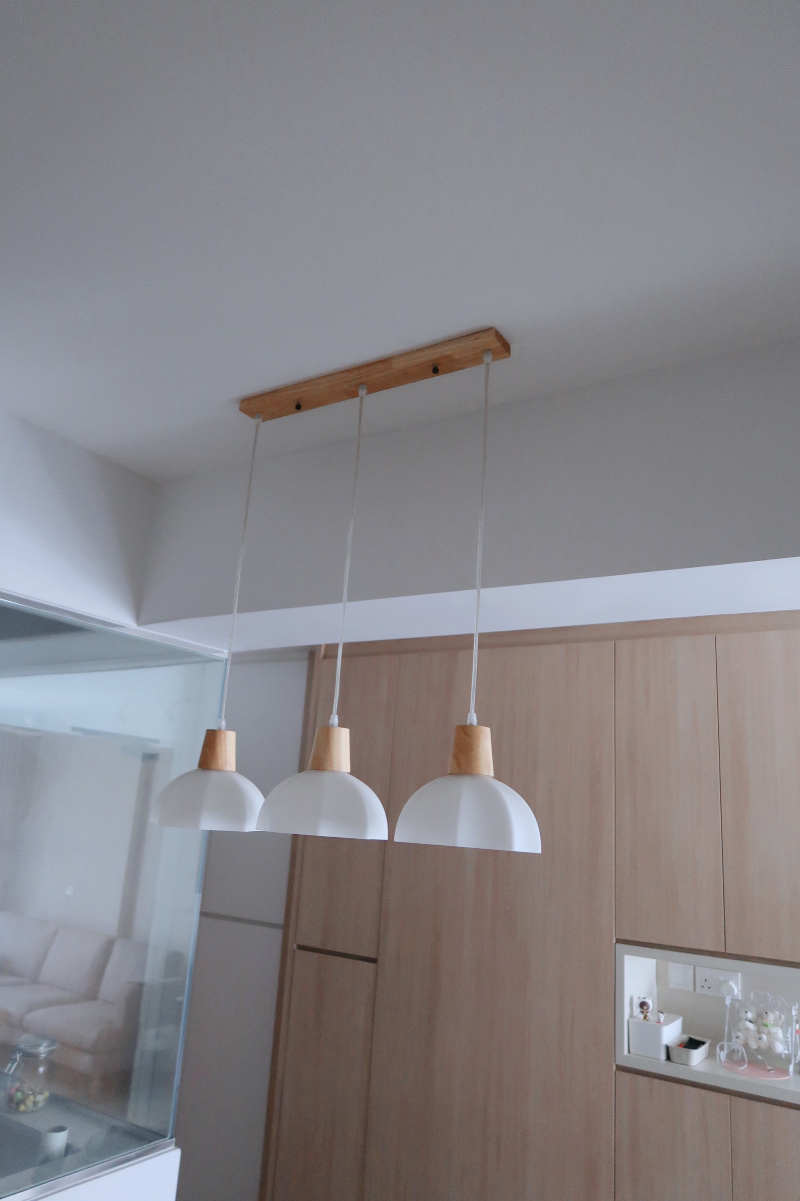 Our Dining Area: Aesthetic dining vibes - Modern minimalist kitchen, wooden pendant lights, sleek cabinetry, contemporary