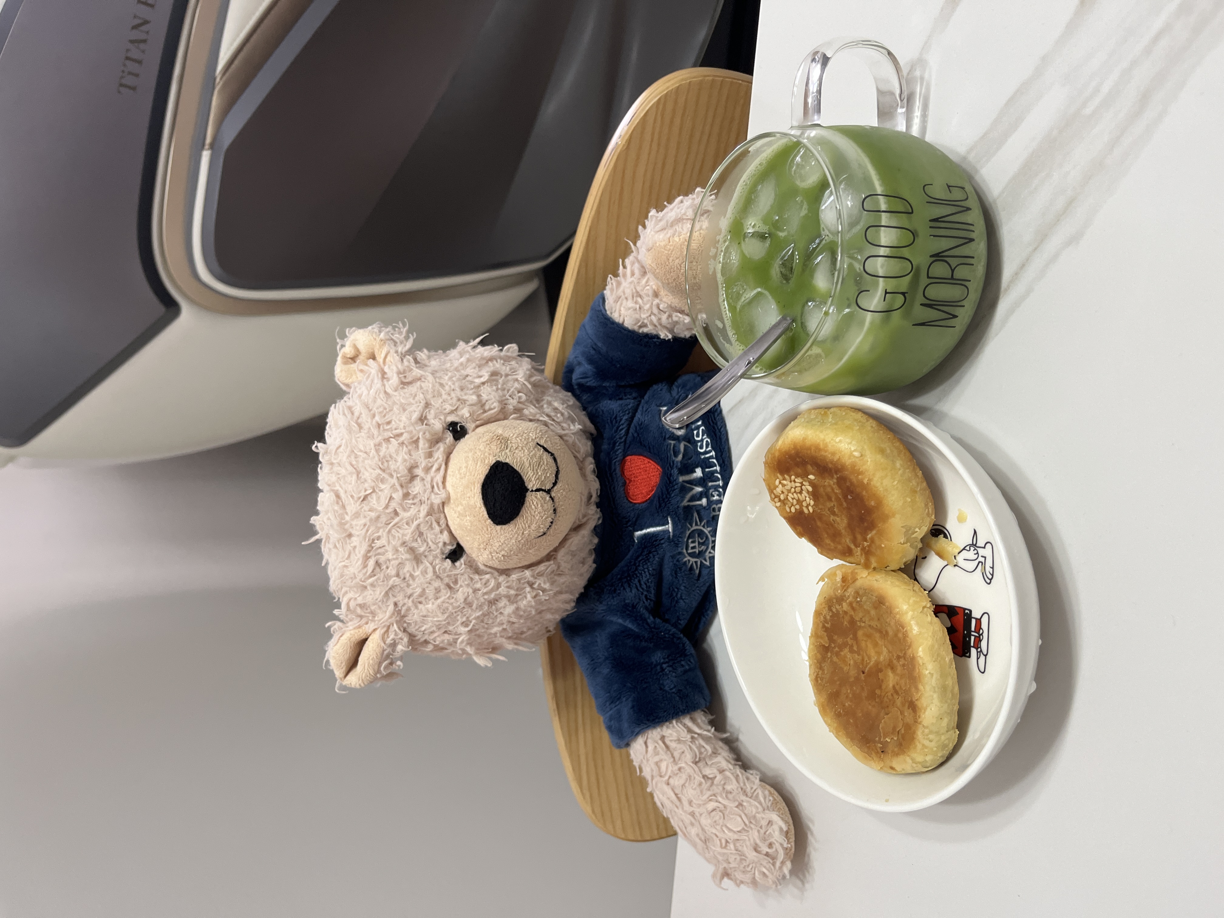 Our Japandi Minimalist Dining Area - Teddy bear, plush toy, white plate, breakfast, pancakes, green tea, cup, cupped hands
