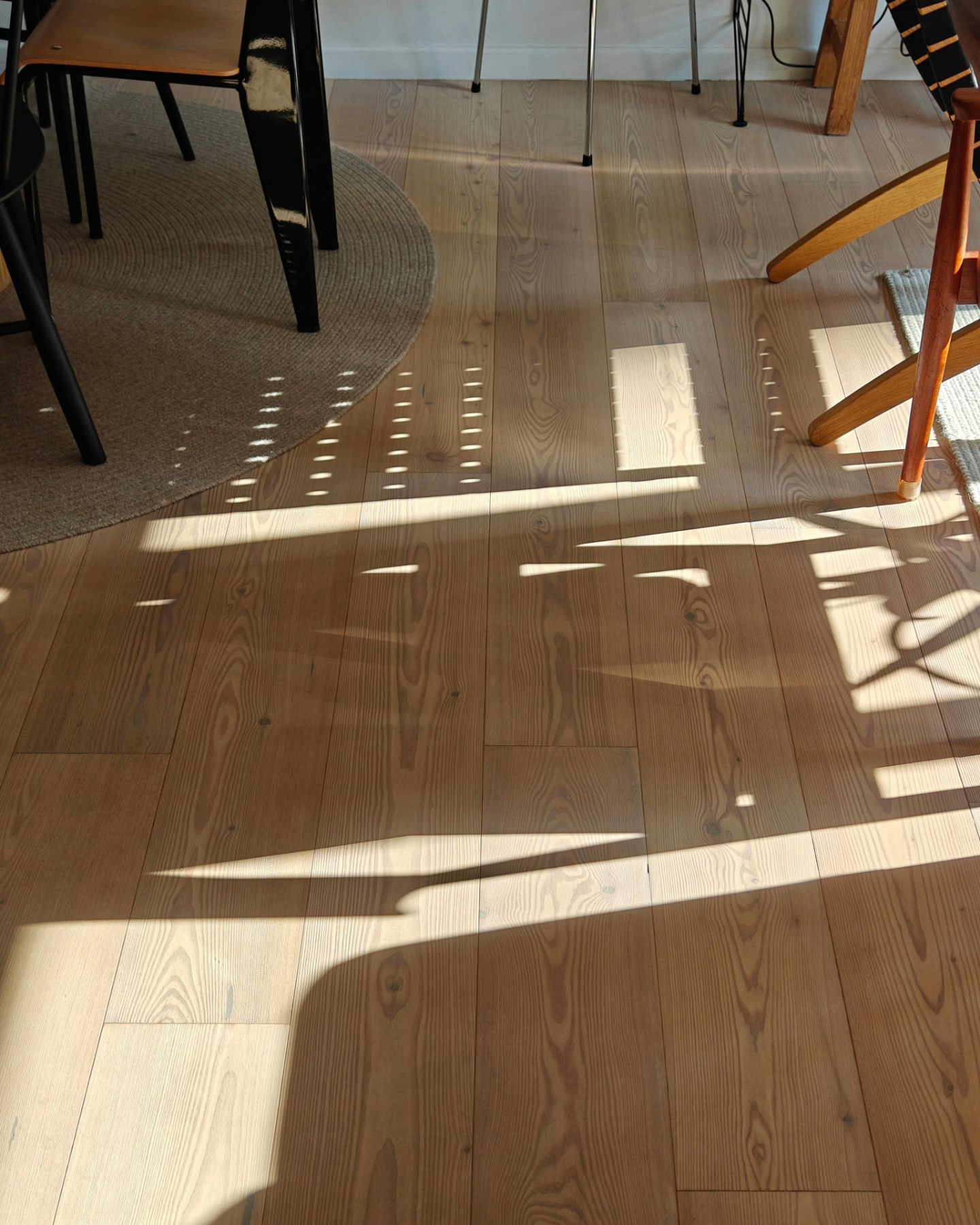A Little Post About Our Home Style  - Sunlight casts intricate shadows on polished wooden floor, highlighting natural wood