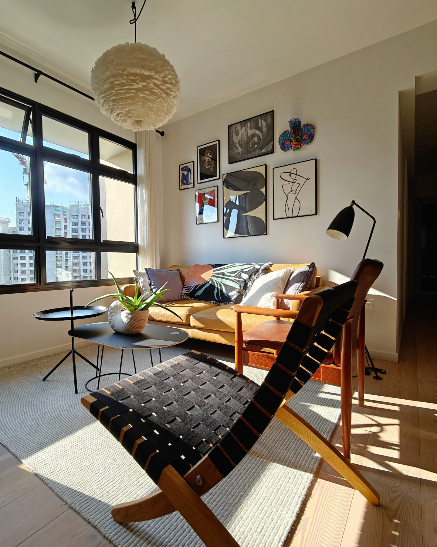 A Little Post About Our Home Style  - Modern living room, large window, natural light, minimalist decor, black and white art