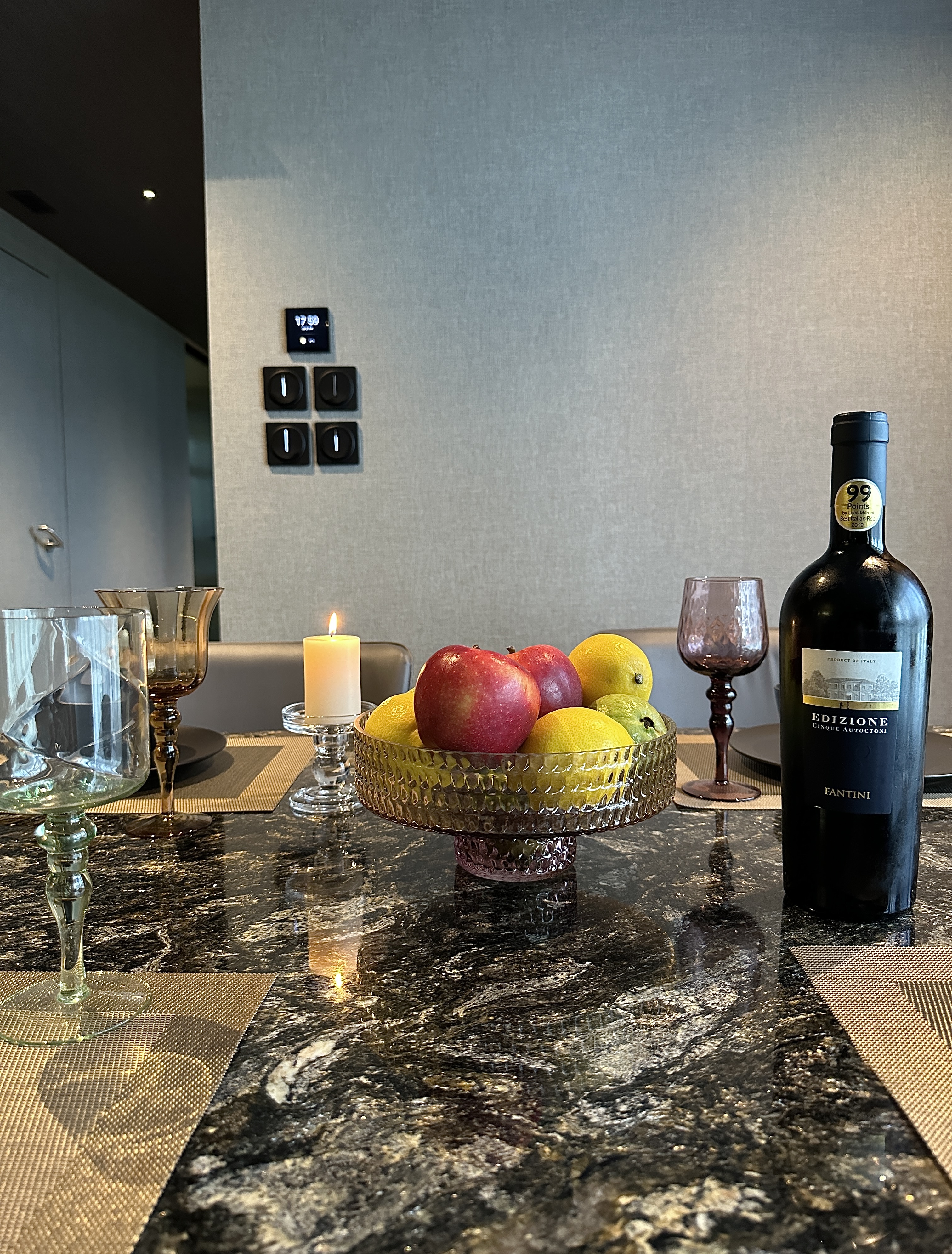 Elegant and Functional: A Glimpse of Our Dark Minimalist Dining Space - marble table, elegant dining, fruit bowl, wine