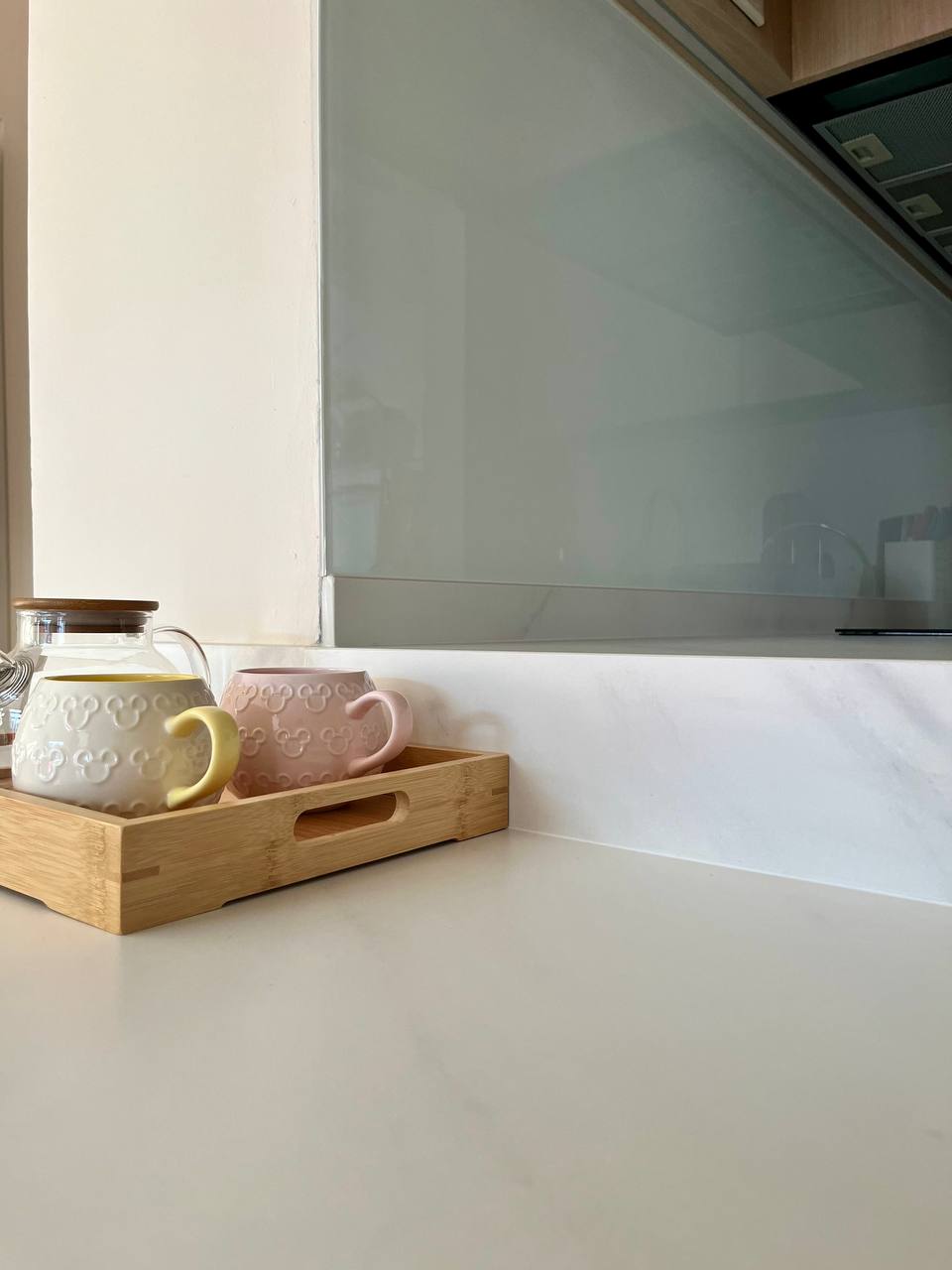 Dining Space: An Extension from Kitchen For Maximised Functionality - Clear glass teapot, wooden tray, pastel pink and white