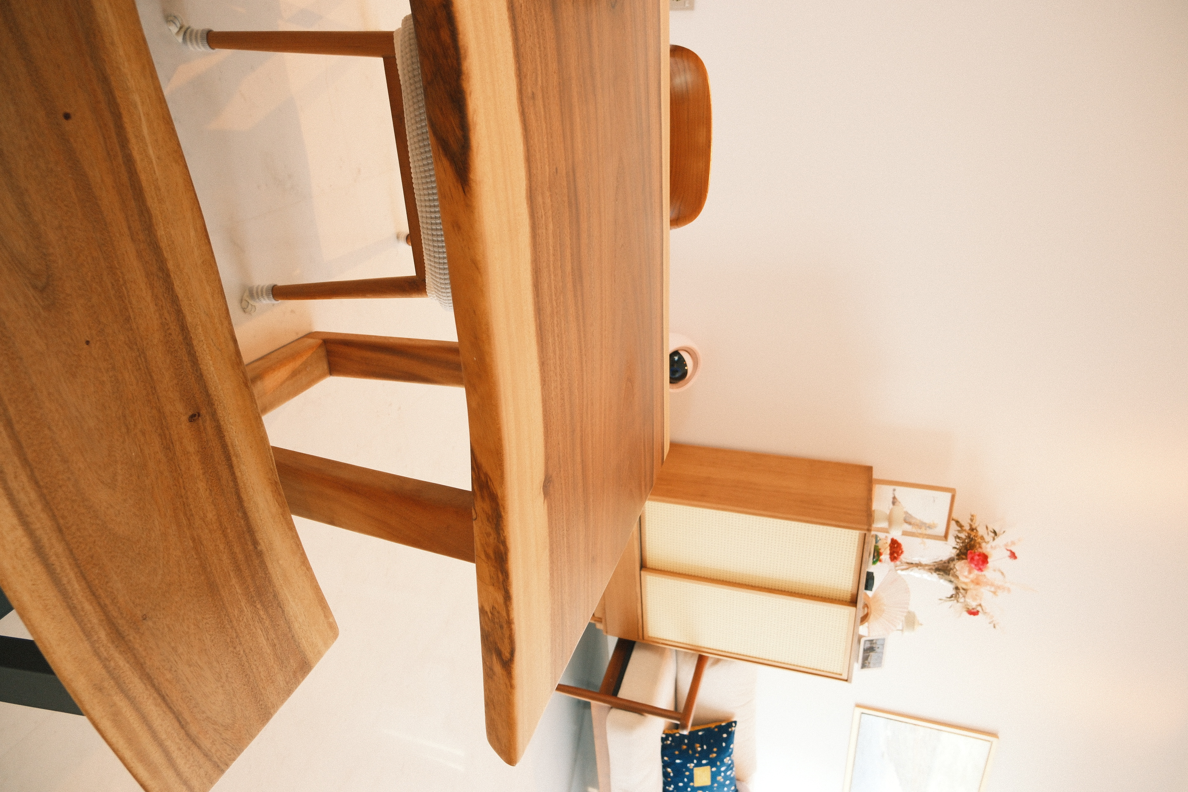 Wes Anderson-style dining room with warm woody tones  - Wooden staircase, wooden railing, wooden steps, wooden handrail