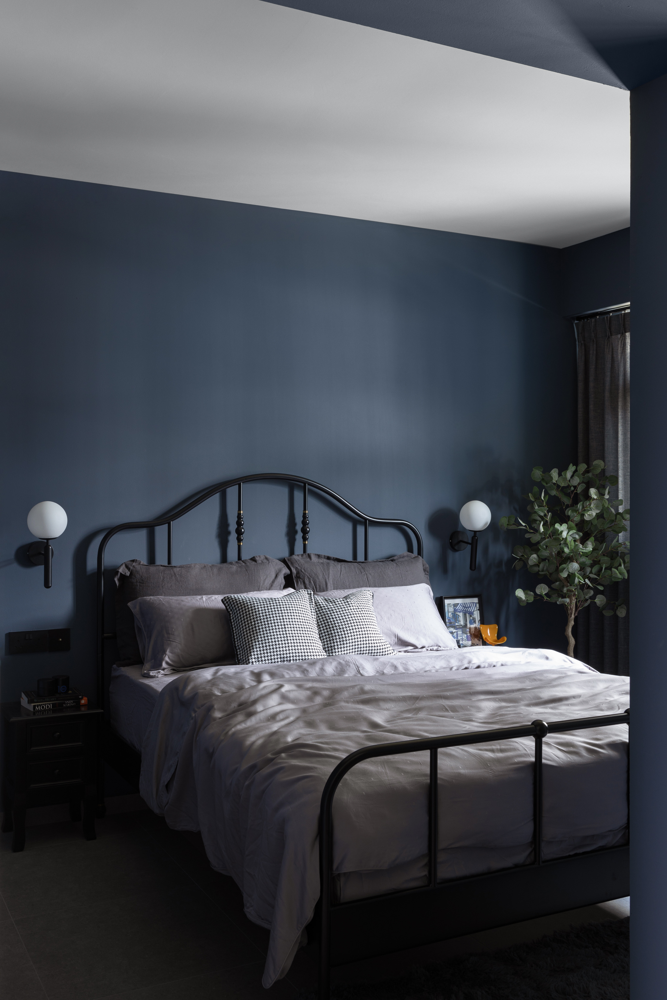 How much do arches cost?  - Dark blue walls, minimalist design, black metal bed frame, gray bedding, white pillows, black