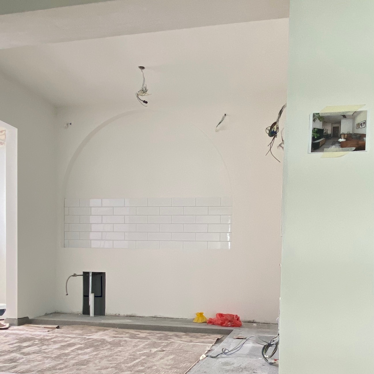 How much do arches cost?  - White-tiled wall, unfinished room, tiled backsplash, exposed pipes, electrical setup, unfinished