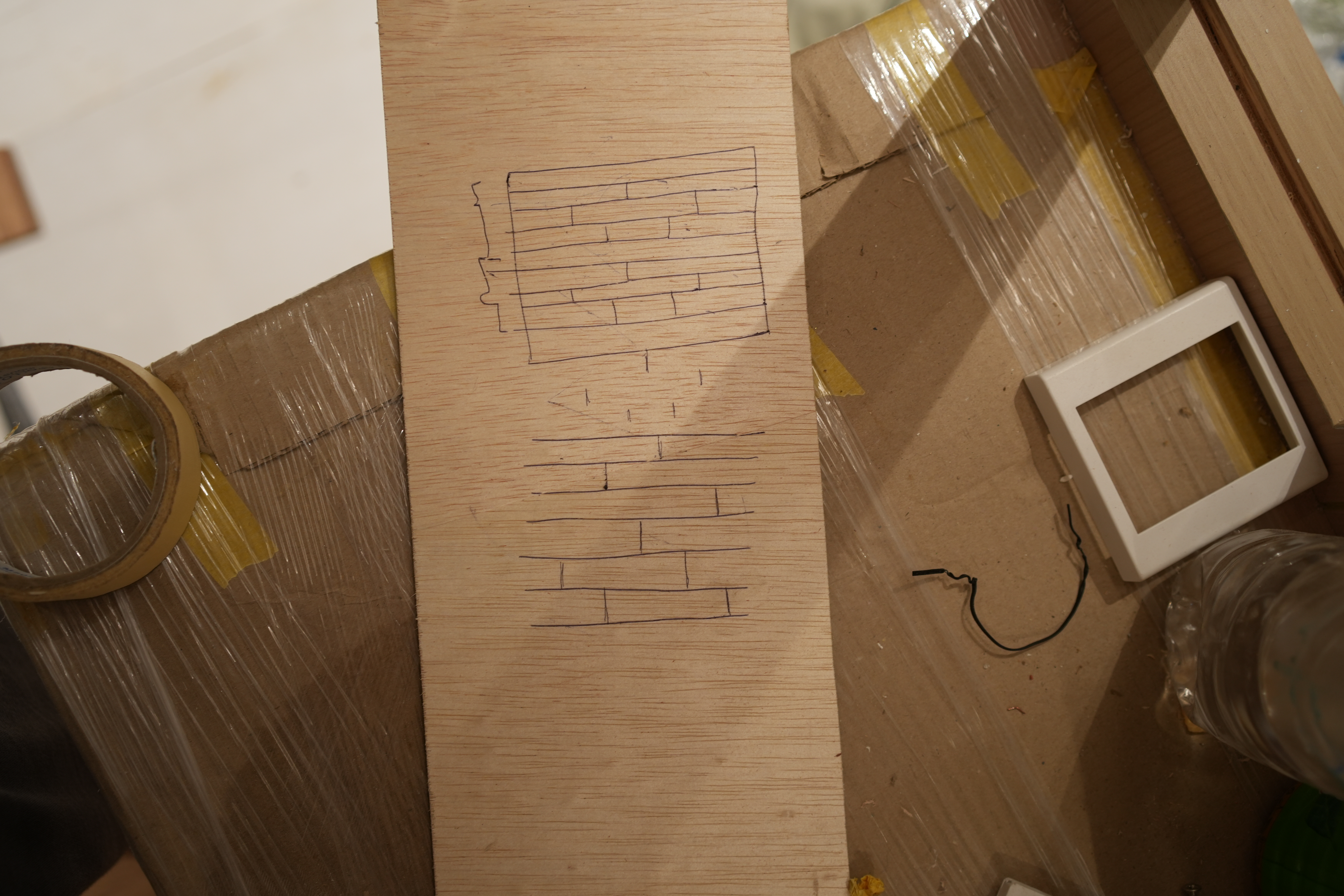 Choosing an ID is as important as choosing your home - Wooden plank with drawn brick pattern, Plastic wrap around cardboard