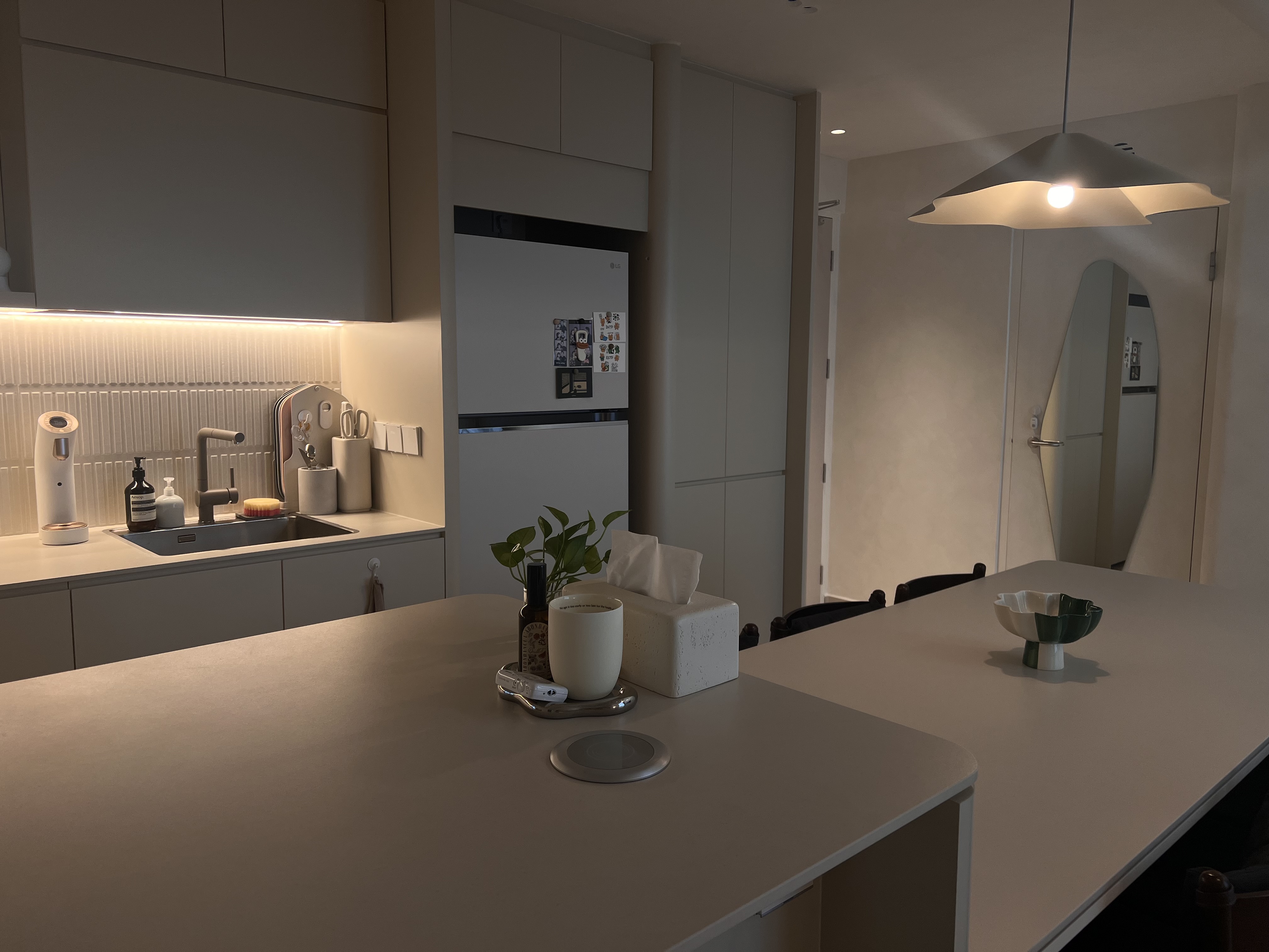 The difference between an Island and a Peninsula - Modern kitchen with sleek design, minimalist decor, soft ambient lighting
