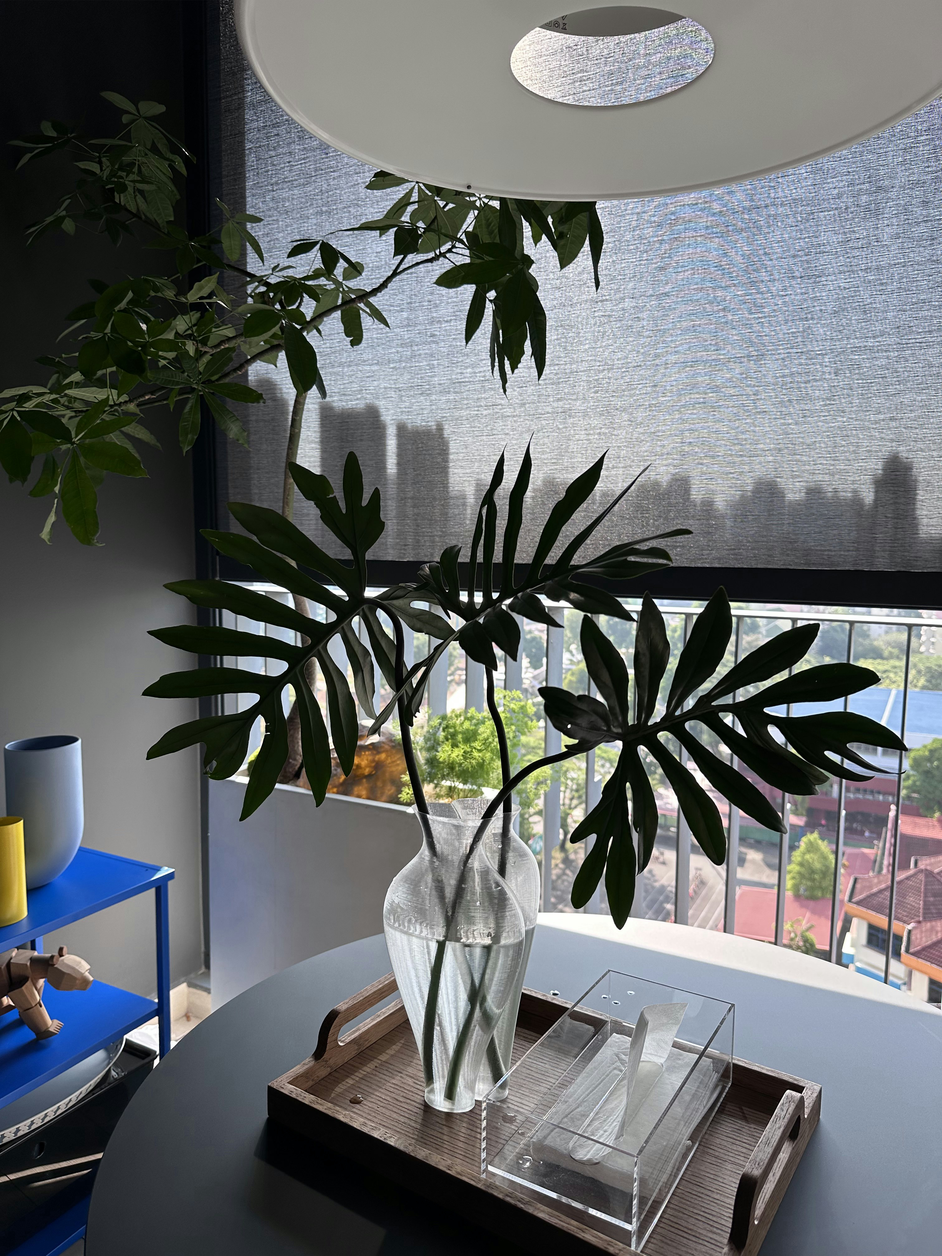 Our Dining Space: Alfresco Dining with Unblocked City View - Modern indoor setting, large potted plant, blue table, abstract