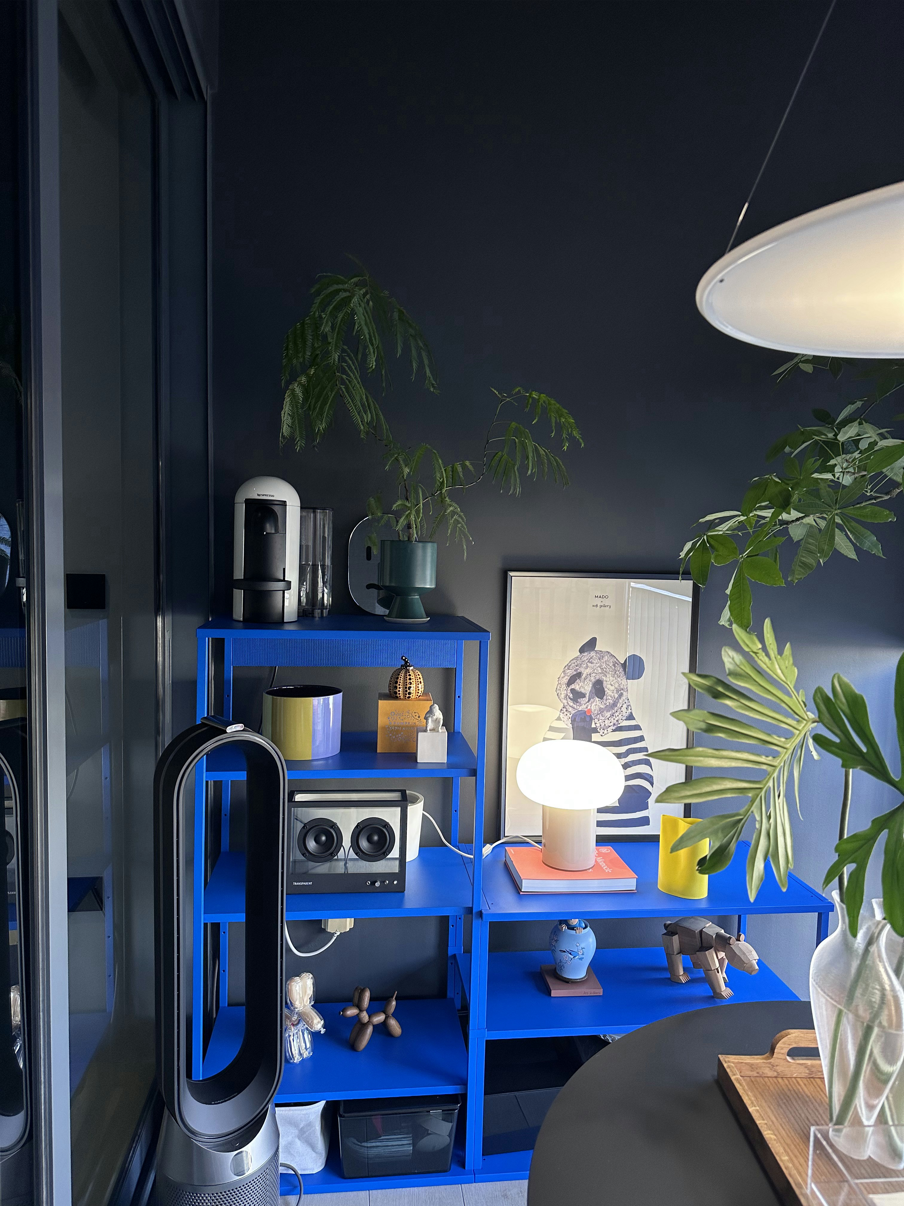 Our Dining Space: Alfresco Dining with Unblocked City View - Blue shelving unit, modern decor, indoor plants, abstract art