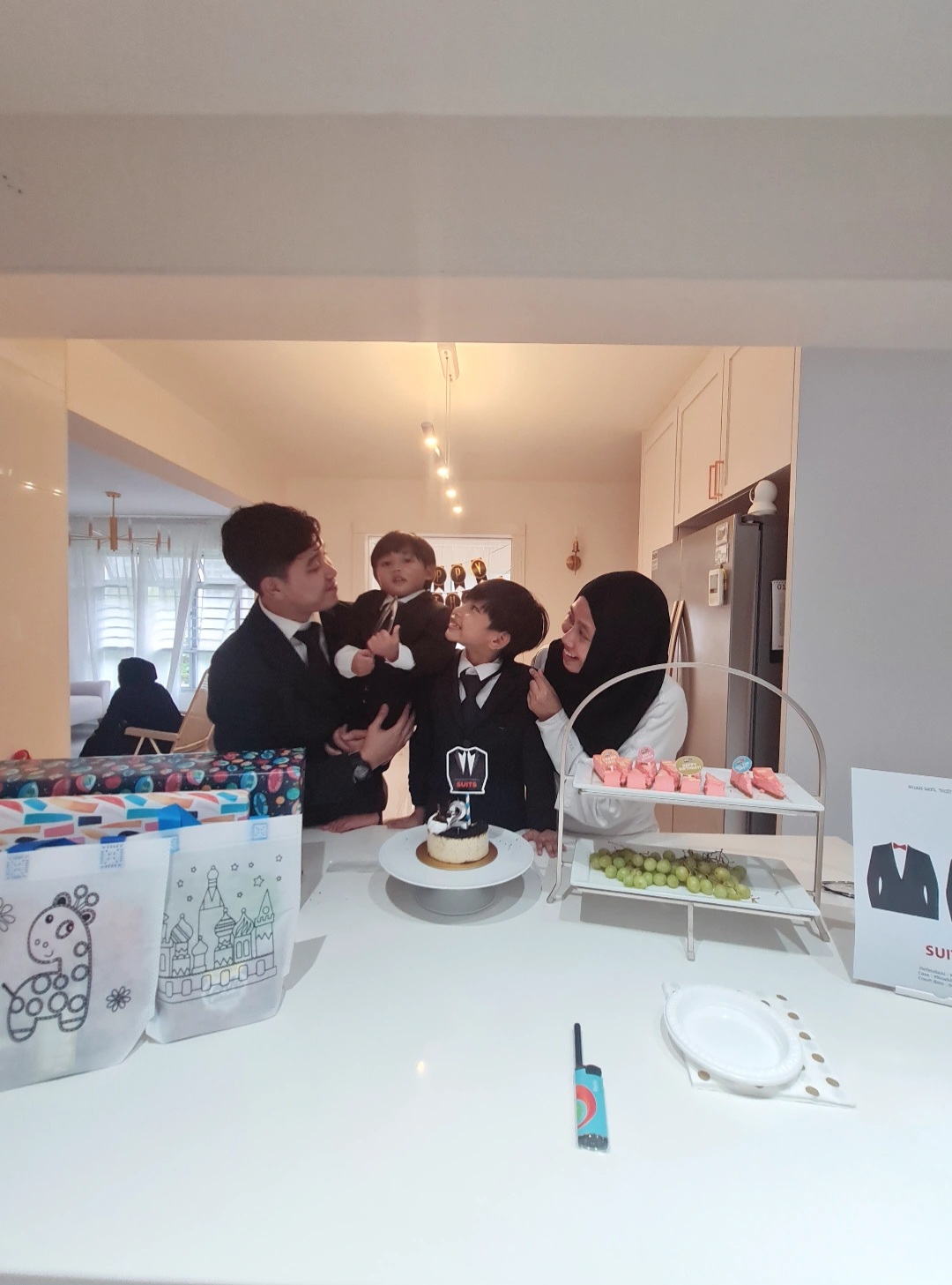 Hosting tips by punggoHField - Family gathering, birthday celebration, children in formal attire, cake with candles, gift