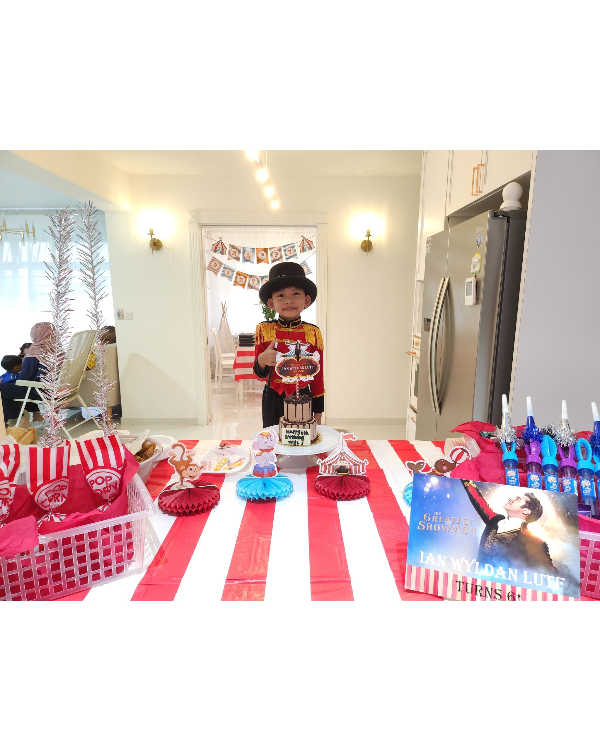 Hosting tips by punggoHField - Children's birthday party decorations, festive red and white striped tablecloth, "The Greatest