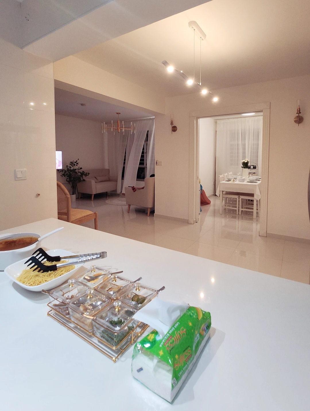 Hosting tips by punggoHField - White dining table, modern kitchen, breakfast tray, clear glass containers, green paper towel