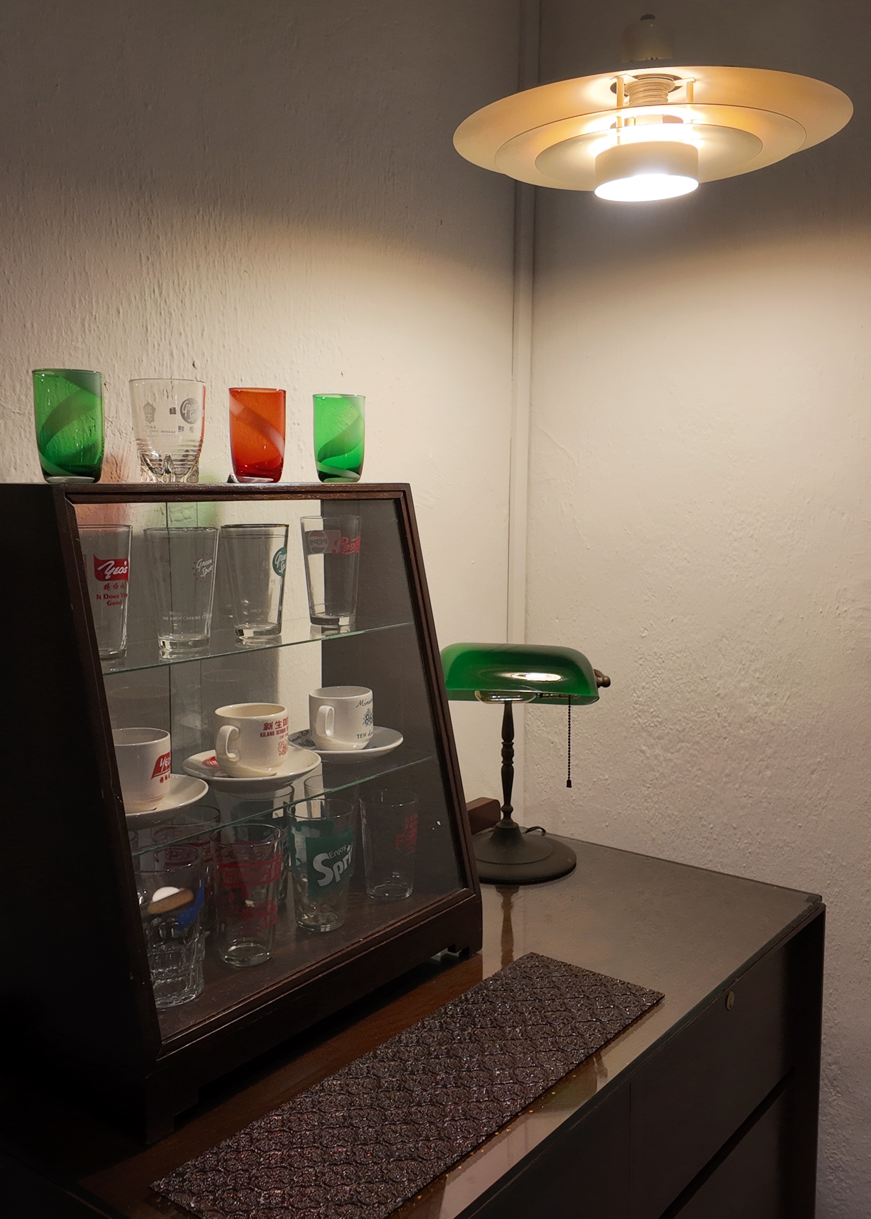 Ling, Ling! Dinner’s served!  - glass display case, green glass cups, red glass cups, white cups, mugs, teacups, measuring