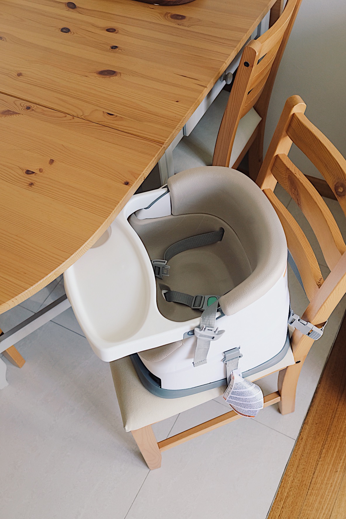 Styling a cosy dining nook in a small home - Wooden dining table, wooden chairs, baby seat, baby carrier, baby seat harness