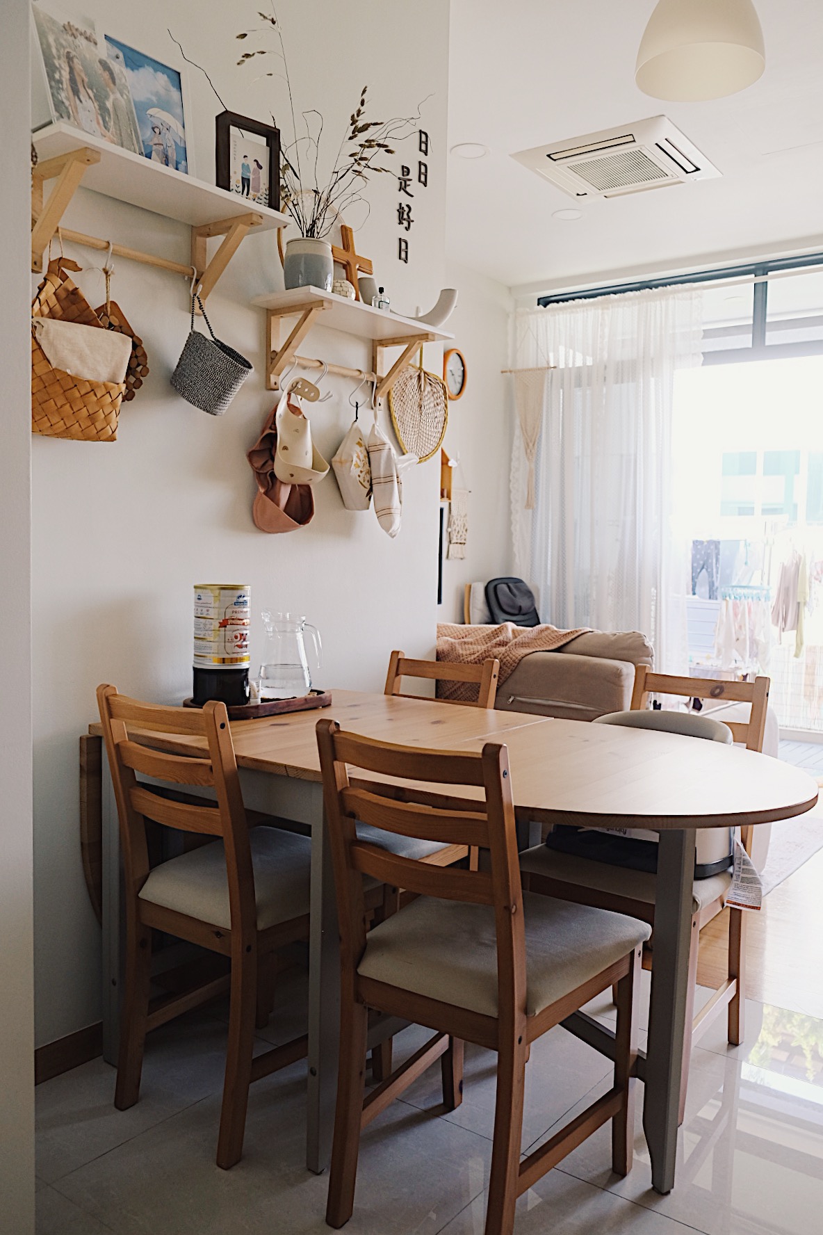 Styling a cosy dining nook in a small home - Wooden dining table, minimalist decor, cozy living room, natural light, white