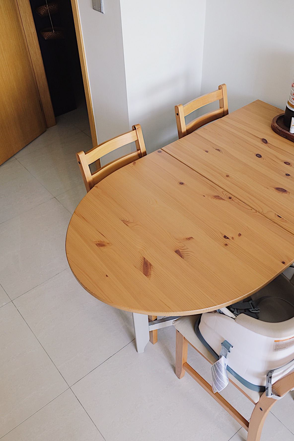 Styling a cosy dining nook in a small home - Wooden dining table, minimalist design, light wood finish, round table, wooden