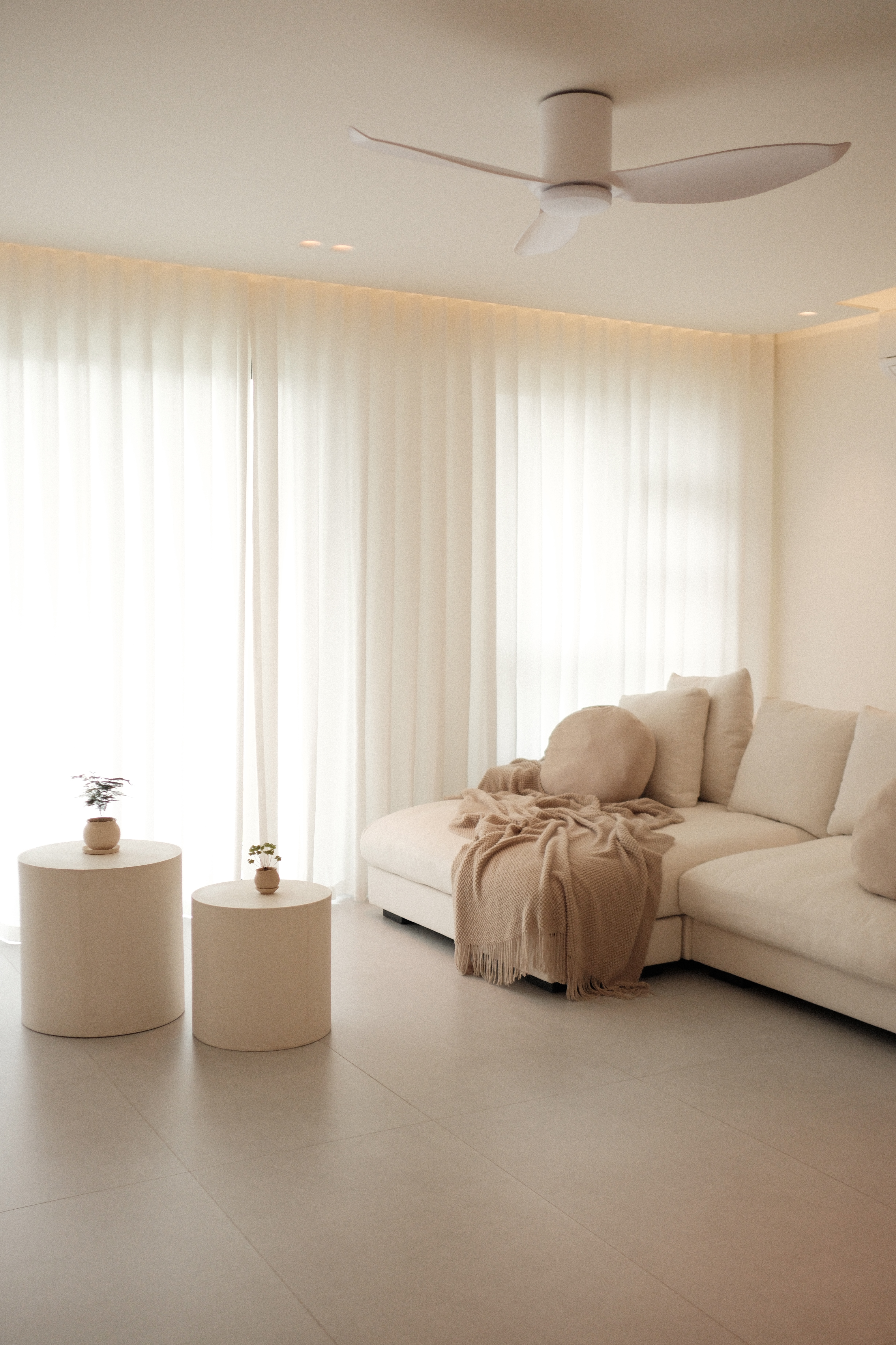Our Living Room: Go Cream Or Go Home - Soft, neutral-toned living room, minimalist design, cozy atmosphere, large windows