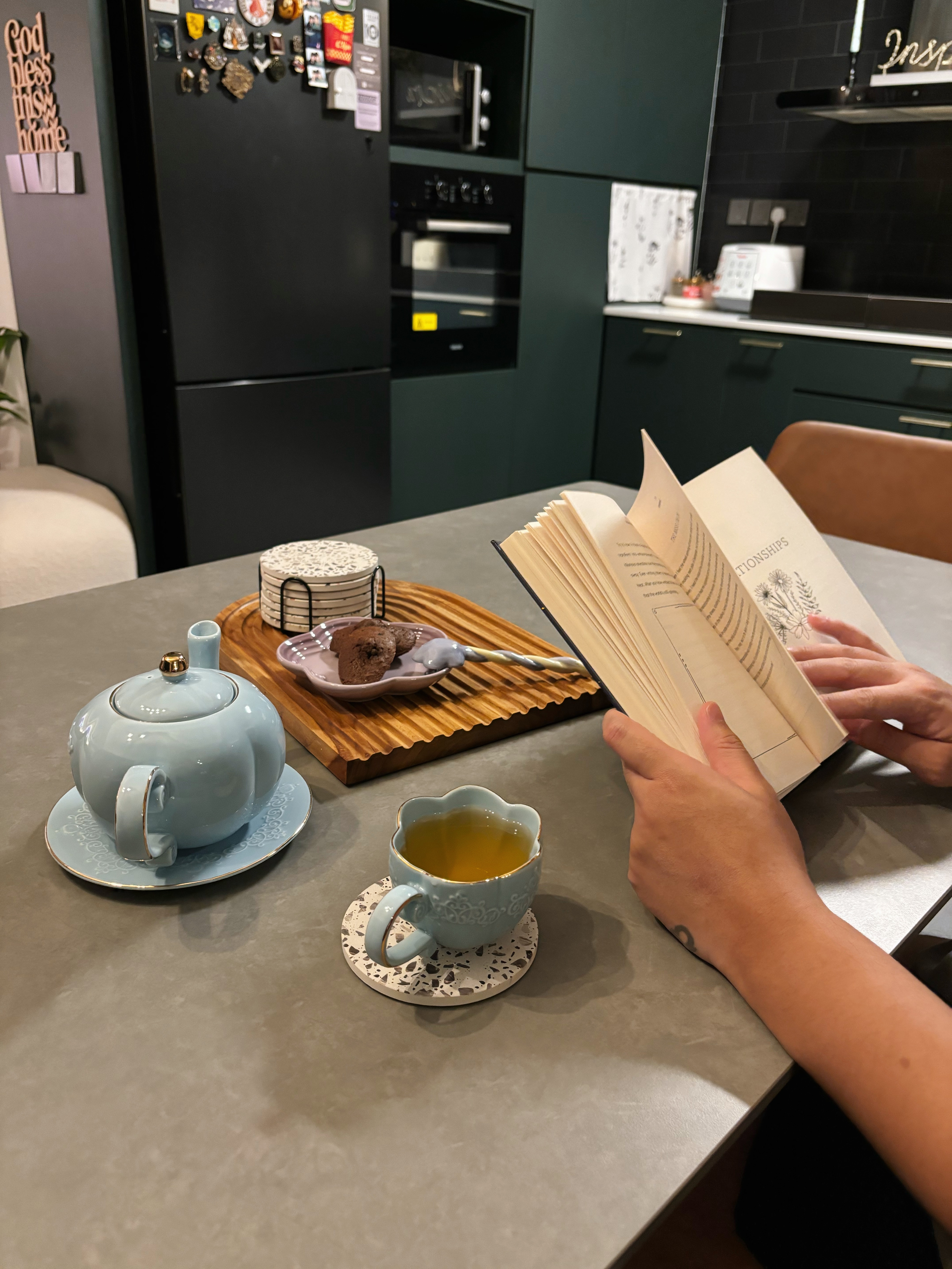 Meal and Greet - Teal teapot, light blue cup, book, tea, cup of tea, cozy atmosphere, modern kitchen, cozy reading spot, book