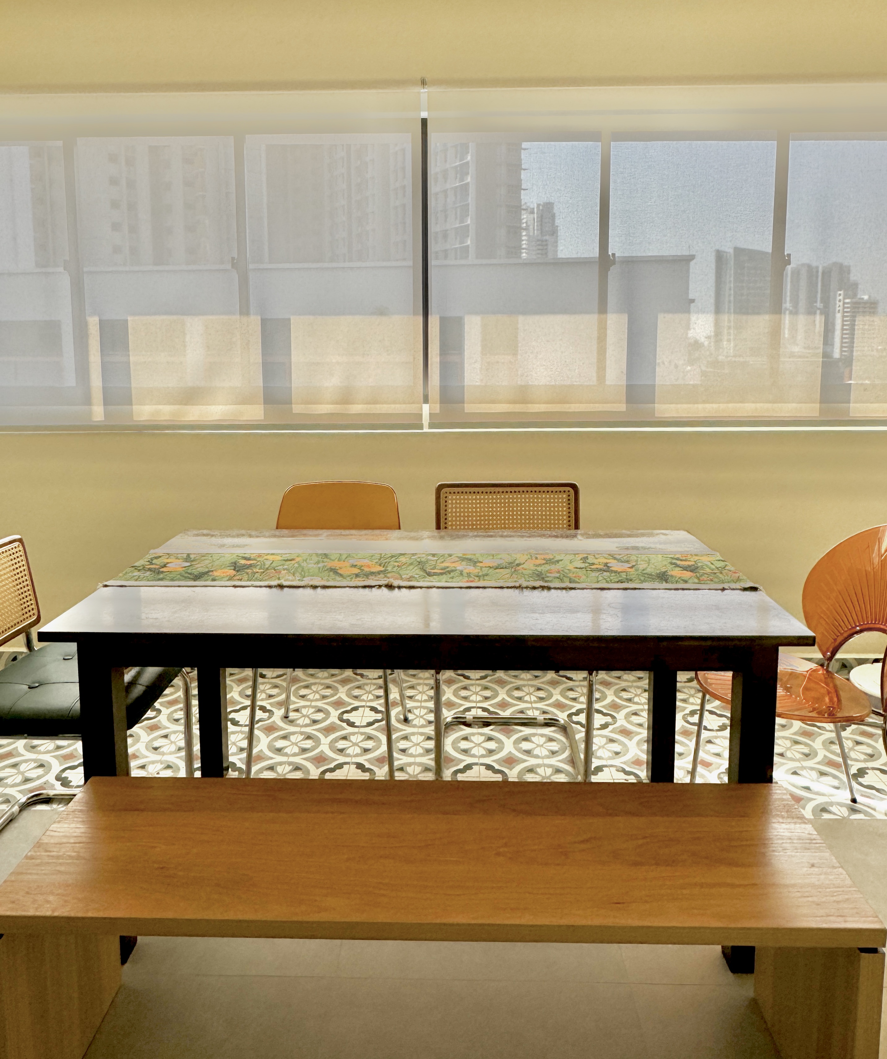 Furnishing our Dining Area for under $250 - Modern dining room, minimalist design, large table, orange chairs, cityscape