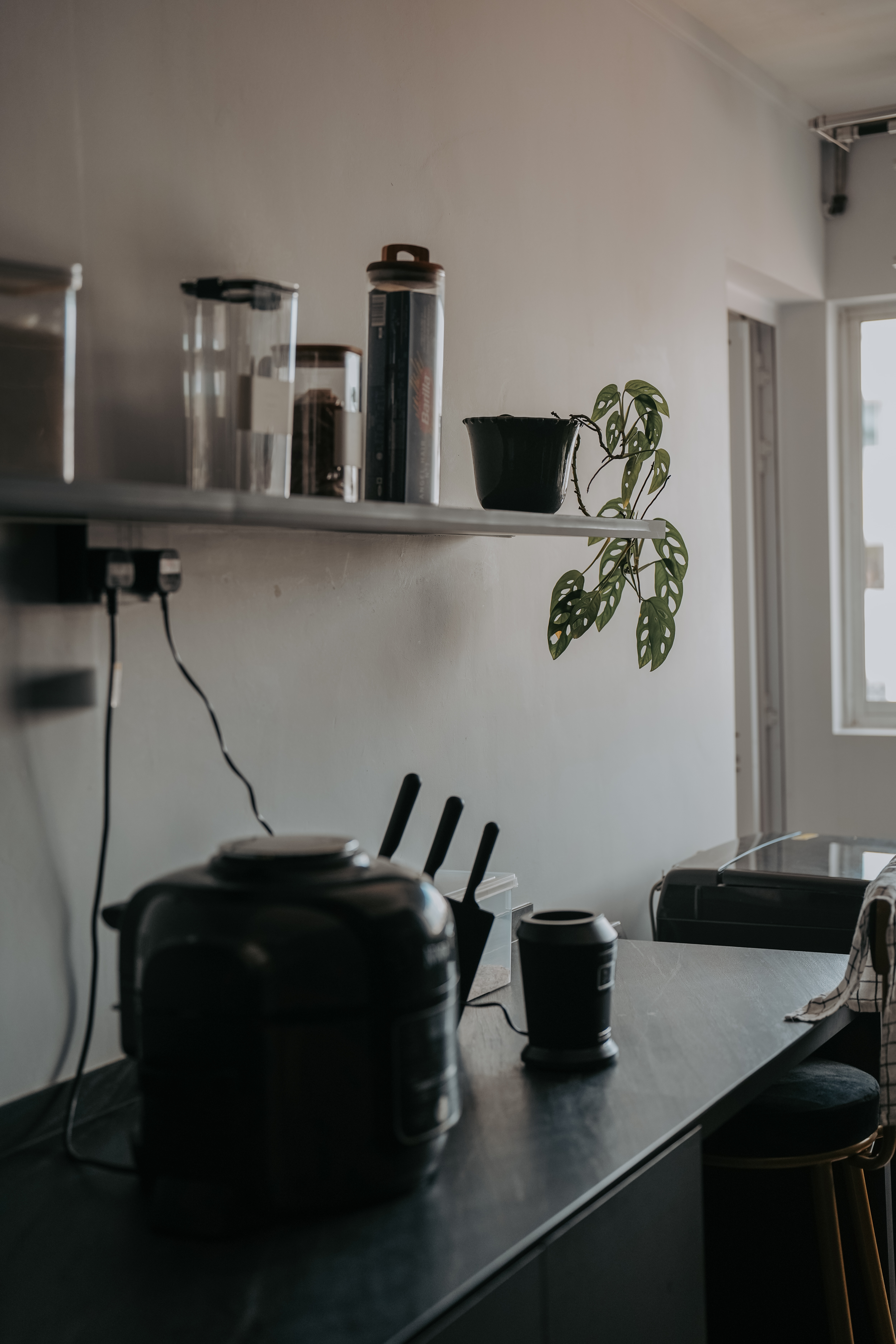 Take a walk in our modern, dark humble 4-room abode! - Shelf with various kitchen appliances, black kettle on dark