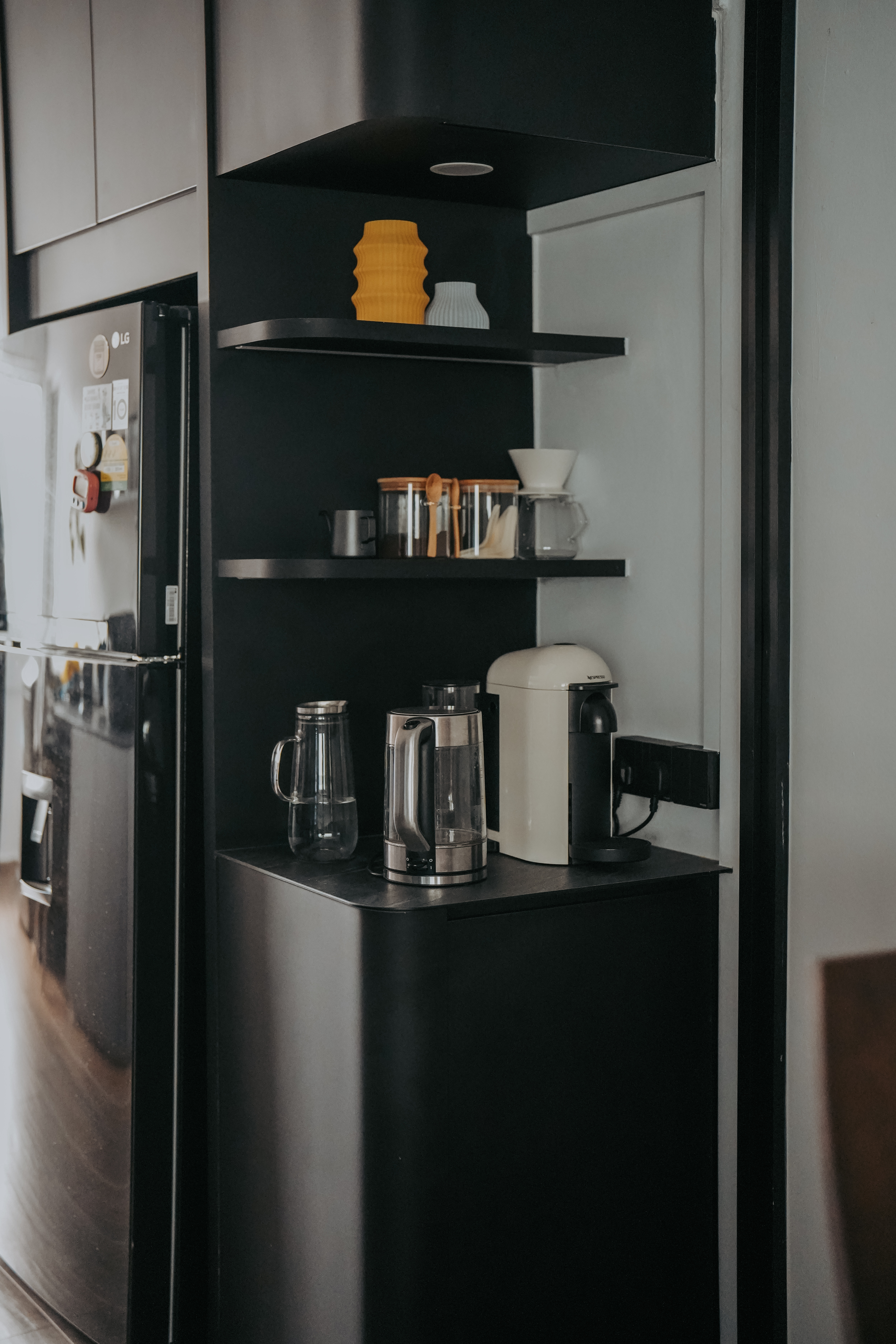 Take a walk in our modern, dark humble 4-room abode! - Modern kitchen, sleek appliances, black cabinets, minimalist design