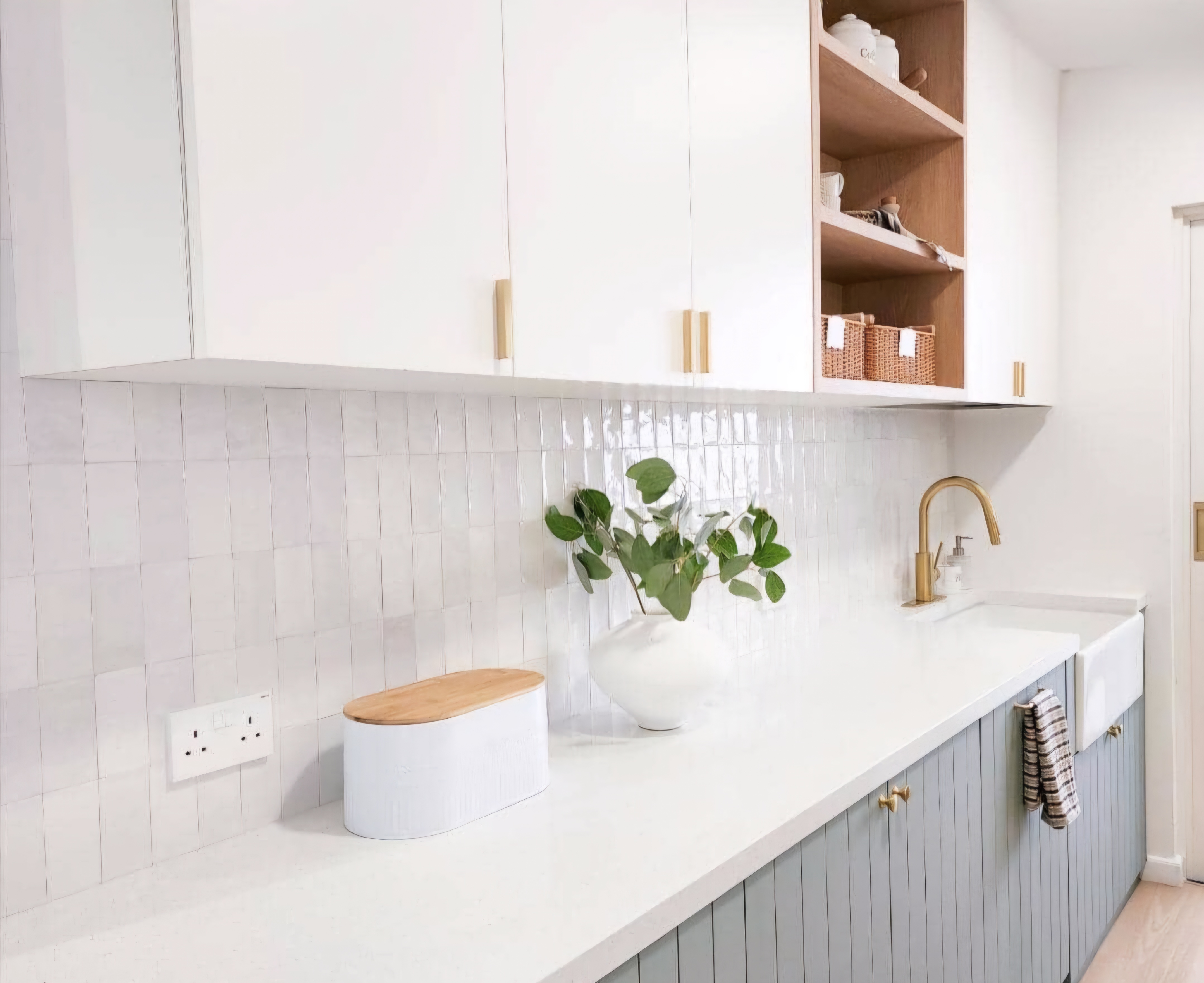 Renders vs. Reality: A Visual Journey - White tiled backsplash, wooden cabinets, light gray countertop, gold faucet, white