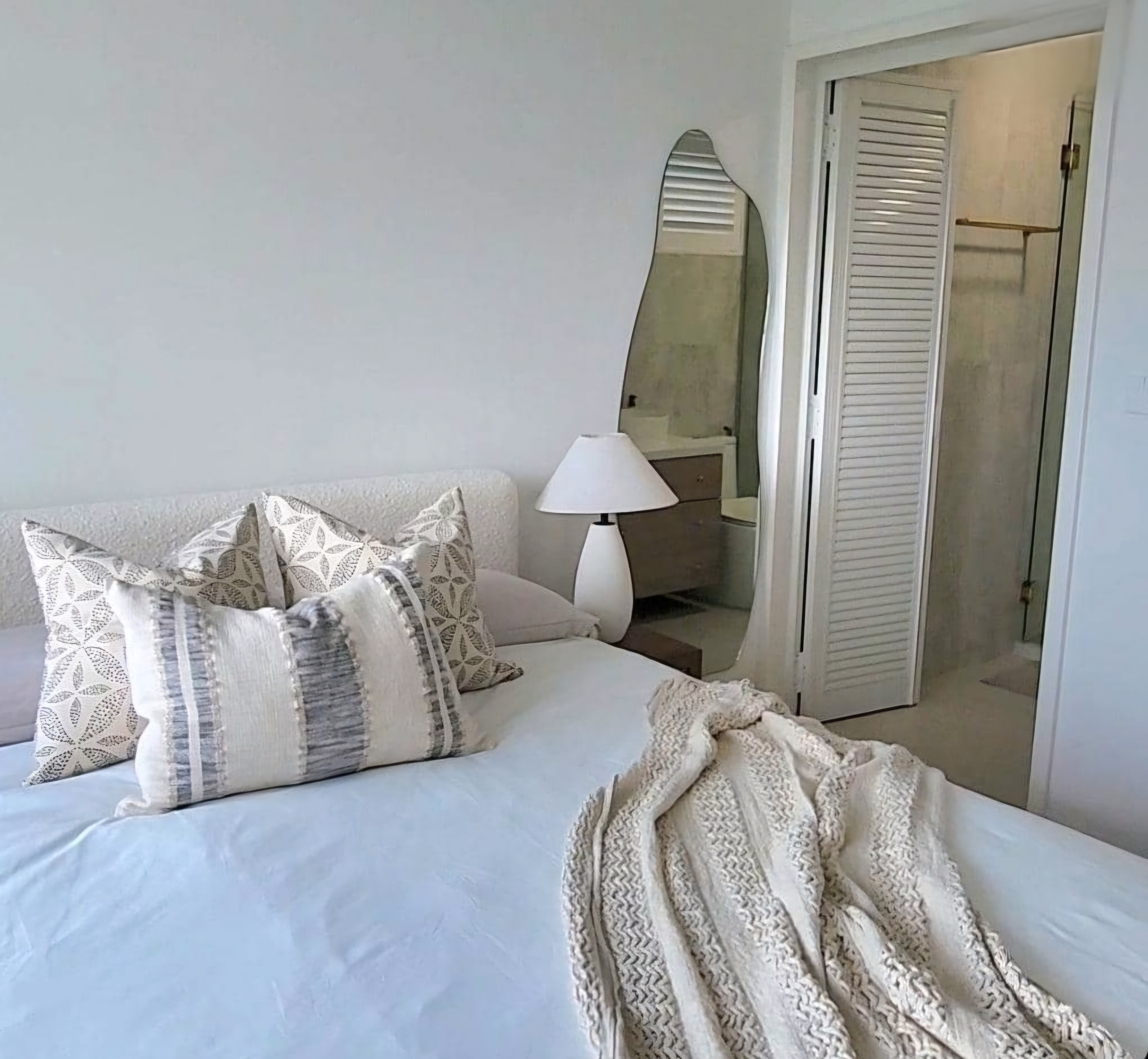 Renders vs. Reality: A Visual Journey - White bedroom with modern design, cozy bed with patterned pillows, beige and gray