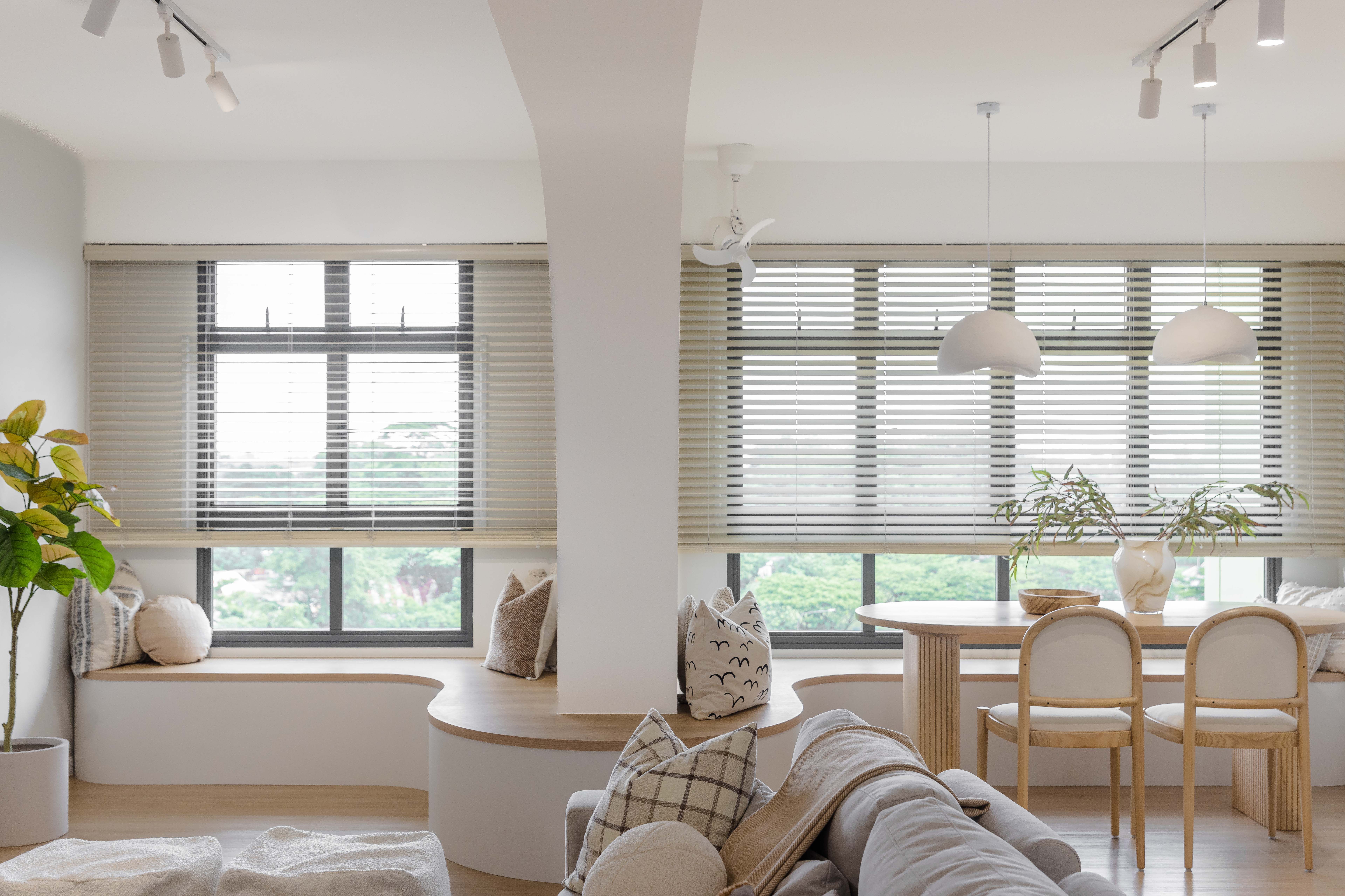 Renders vs. Reality: A Visual Journey - Modern living room with large windows, white and beige tones, minimalist furniture