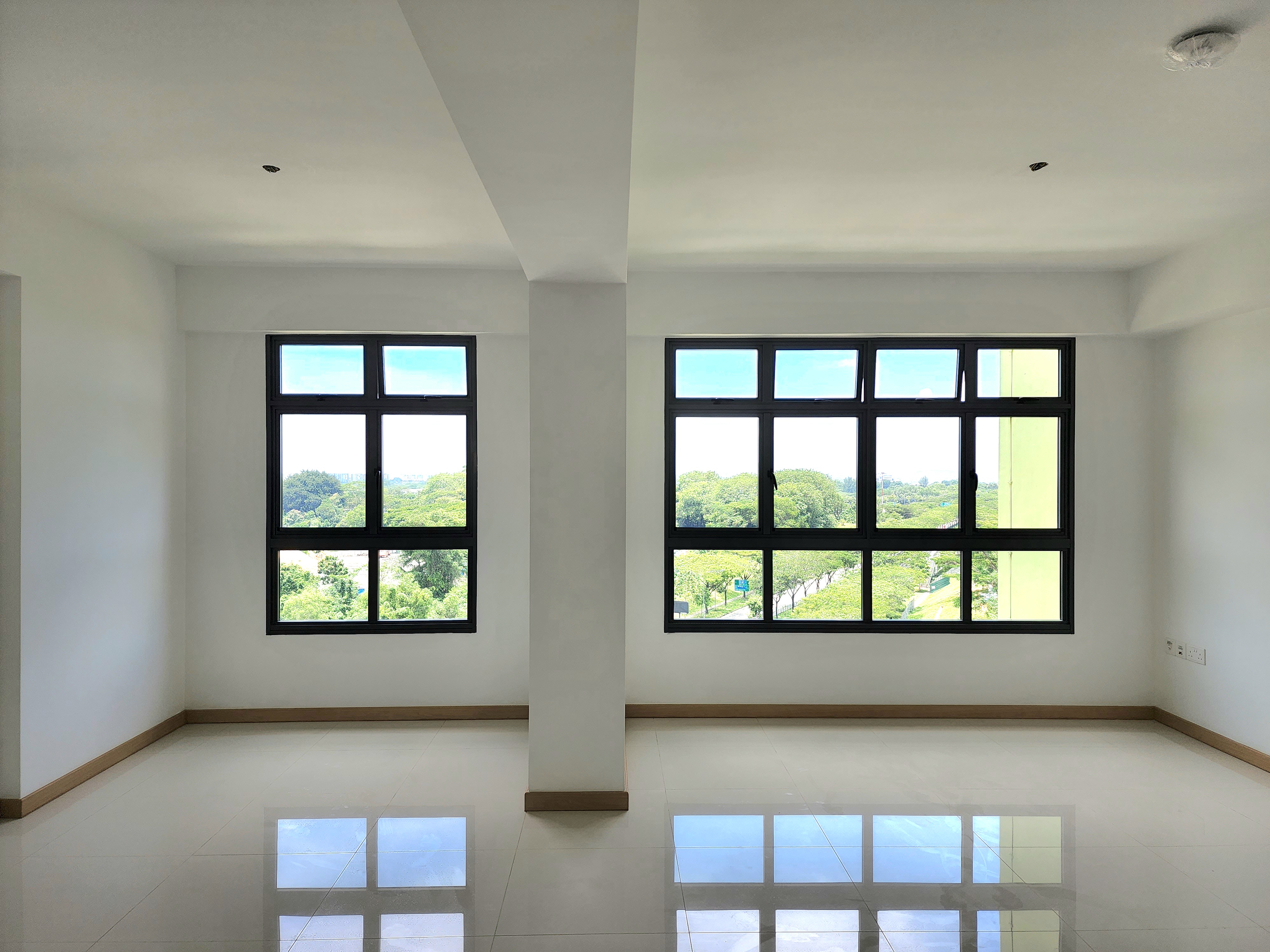 Renders vs. Reality: A Visual Journey - Modern minimalist interior, spacious room, large windows, bright daylight, white