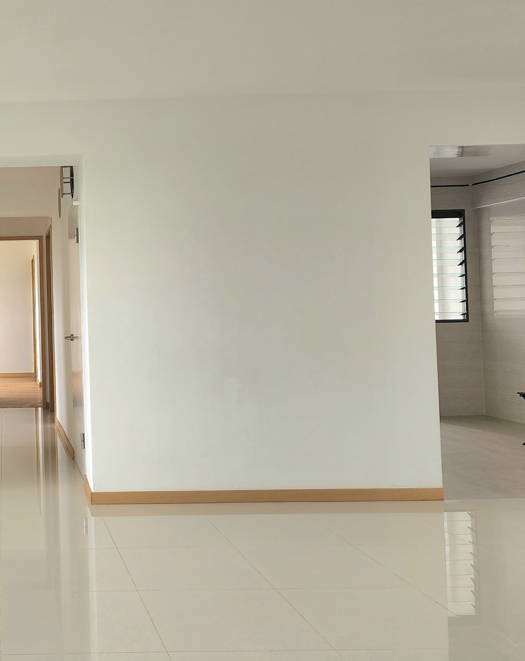 Renders vs. Reality: A Visual Journey - White walls, glossy floor, minimalist design, modern interior, open doorways, bright