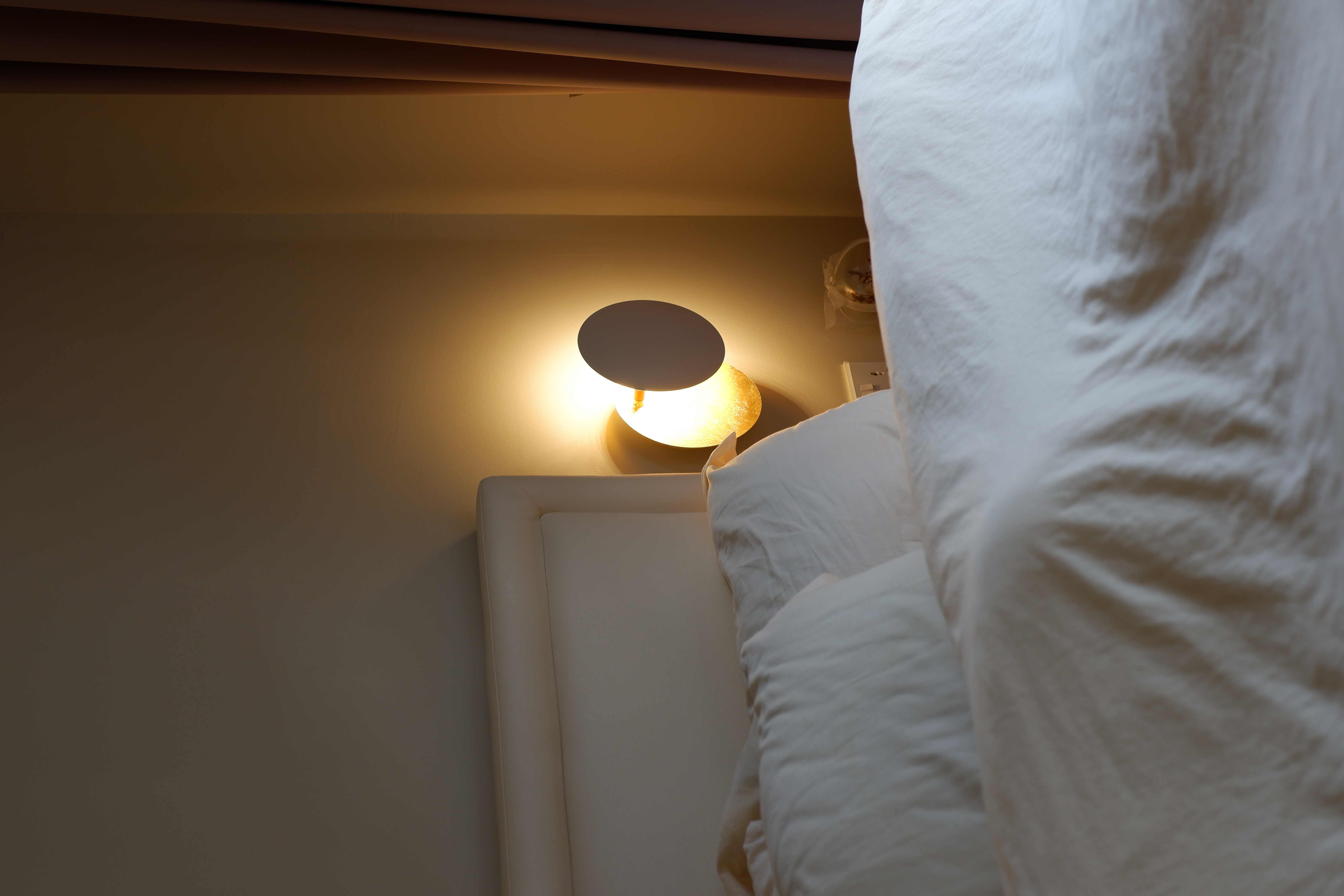 Our cosy bedroom with minimal carpentry with a bag display cabinet  - Warm glow from bedside lamp, soft lighting, cozy