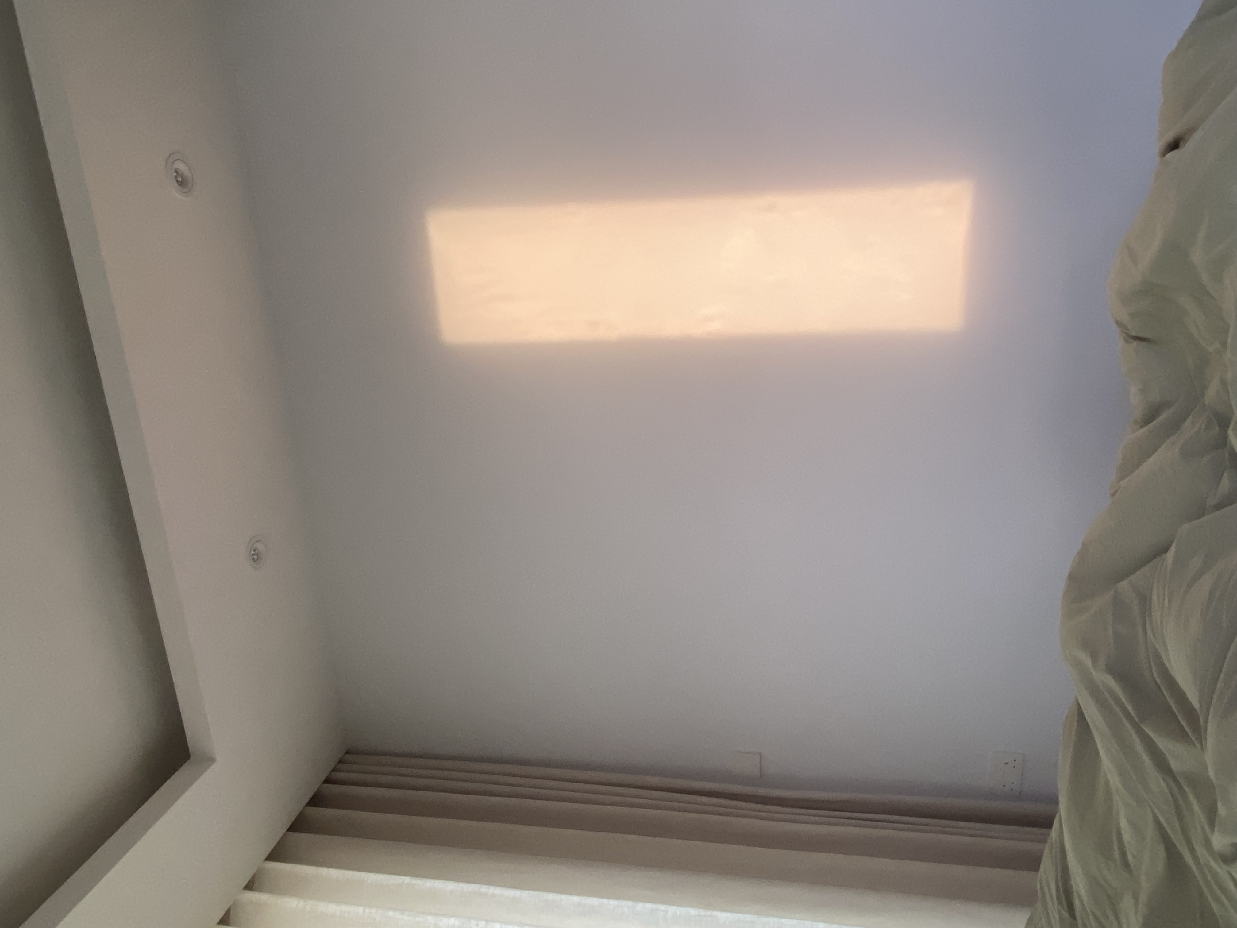 Our master bedroom with only a king sized bed and built-in wardrobe - Sunlight streaming through a rectangular window, soft