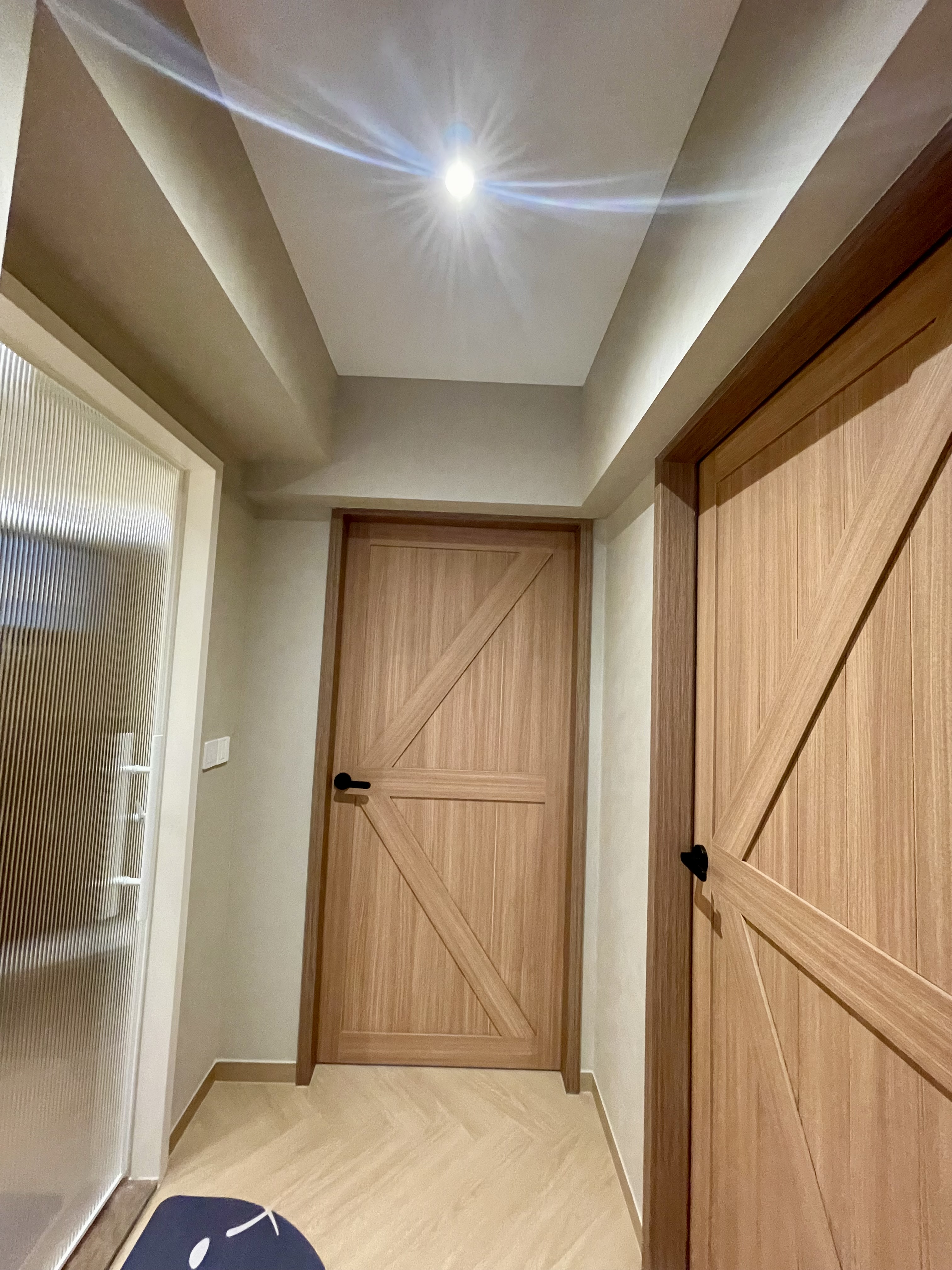 A Cosy Sanctuary: Our Slumber Haven With A Concealed Bathroom & Vanity - Wooden door with black handle, beige walls, ceiling