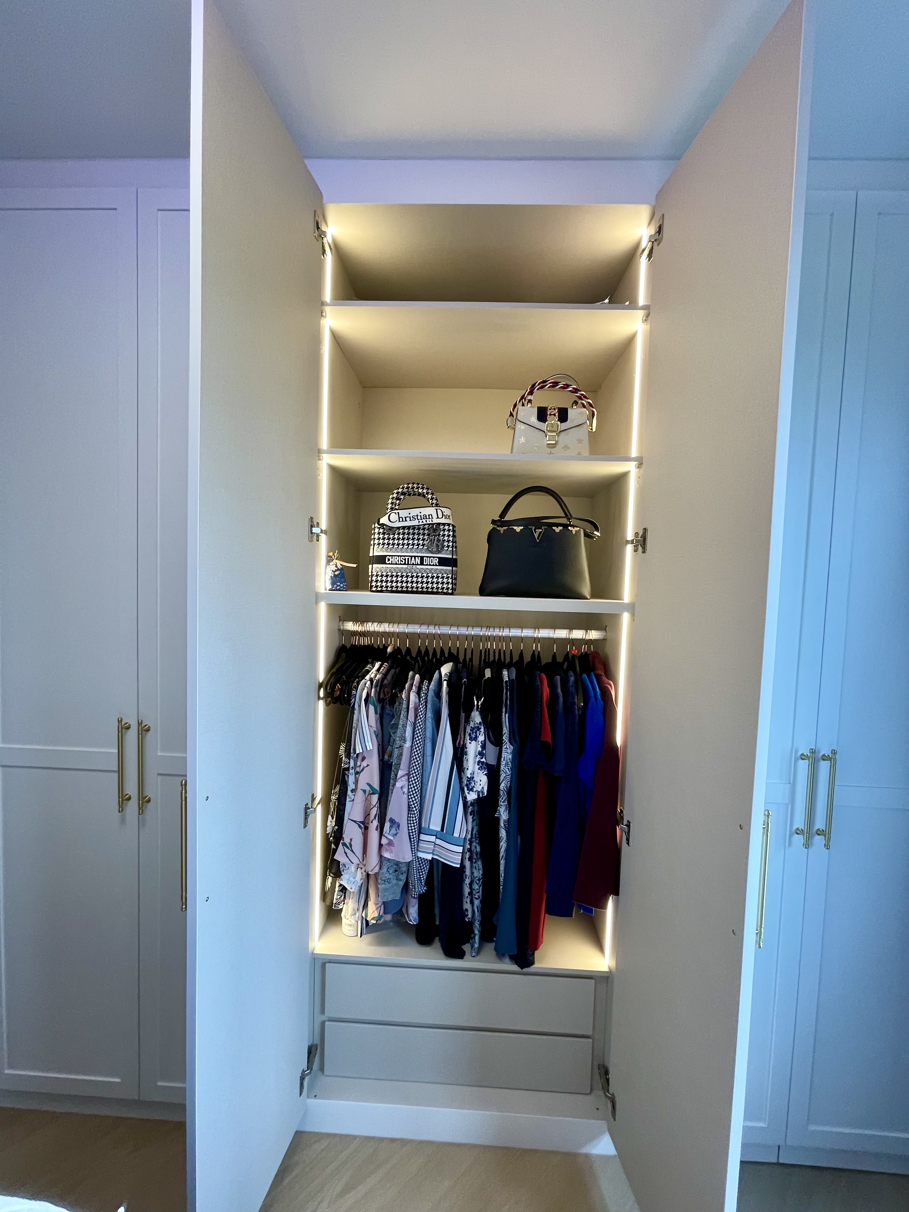 A Cosy Sanctuary: Our Slumber Haven With A Concealed Bathroom & Vanity - Shelving unit with illuminated compartments, neatly