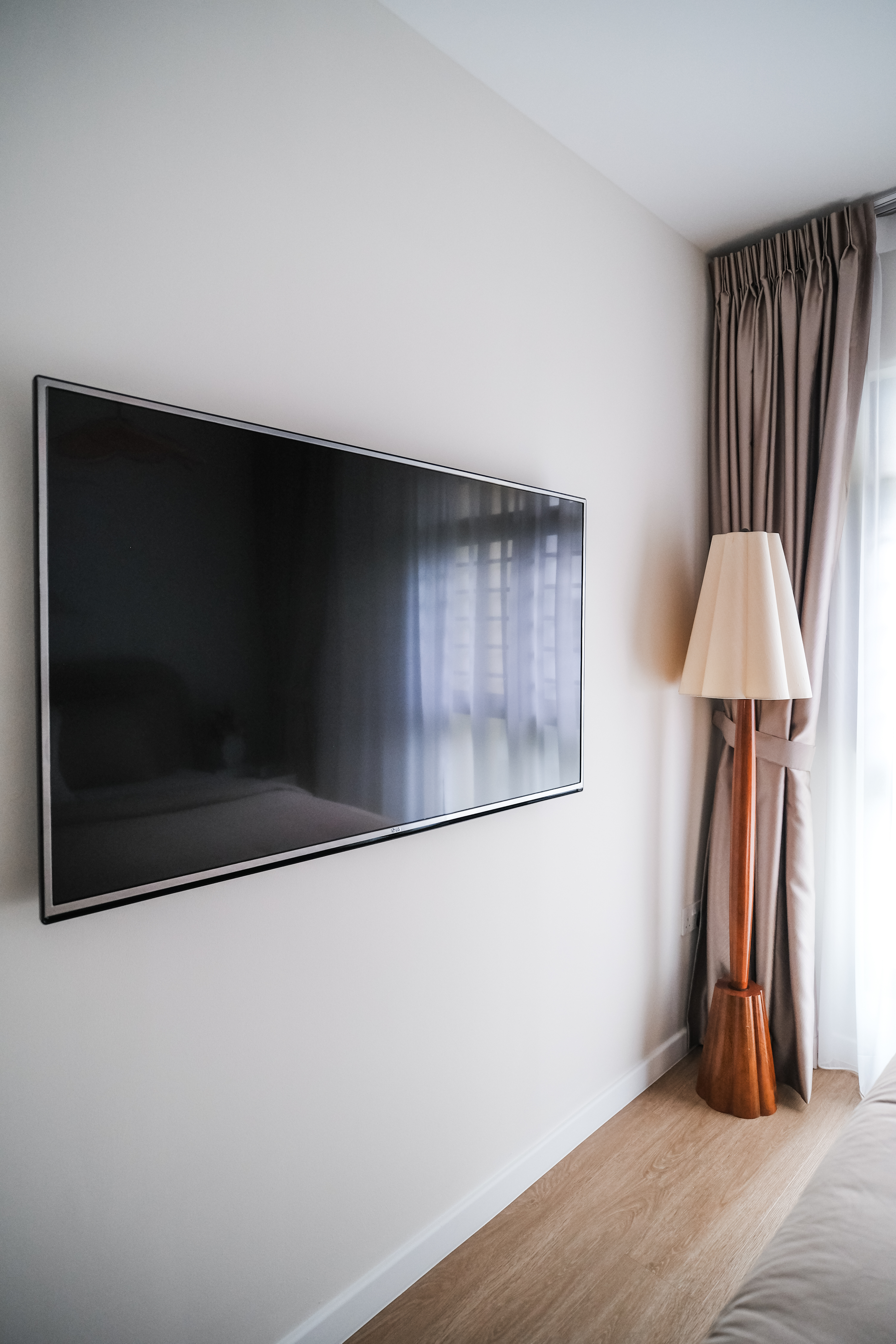 Calming Modern Bedroom in Creme Tones with DIY Wall Art - Large flat-screen TV, minimalist decor, modern room, light-colored