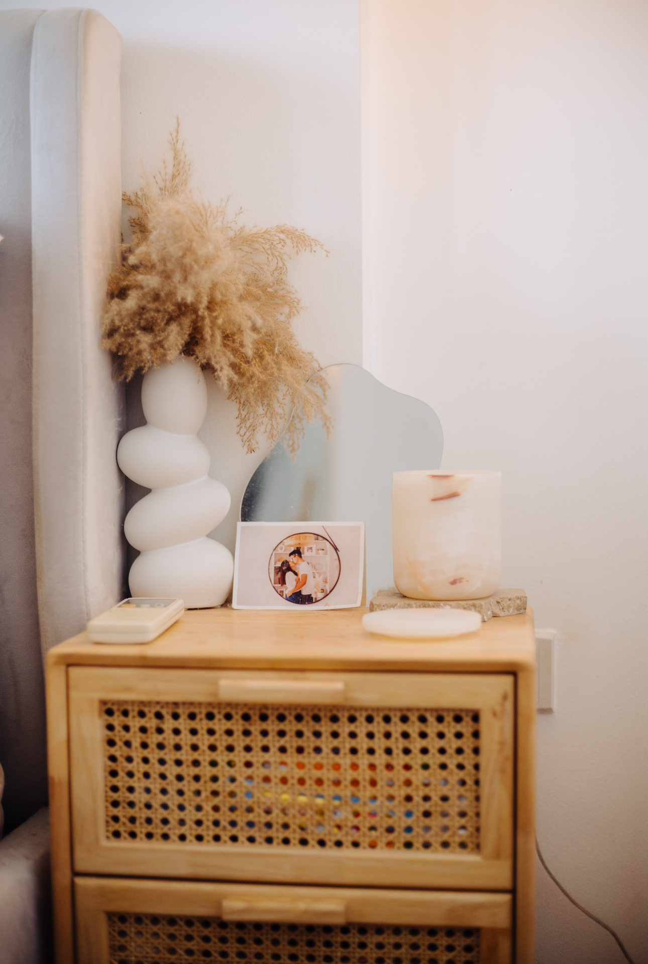 Our Bedroom: How We Changed It At Different Phases In Our Lives - vase with dried flowers, white abstract sculpture, wooden