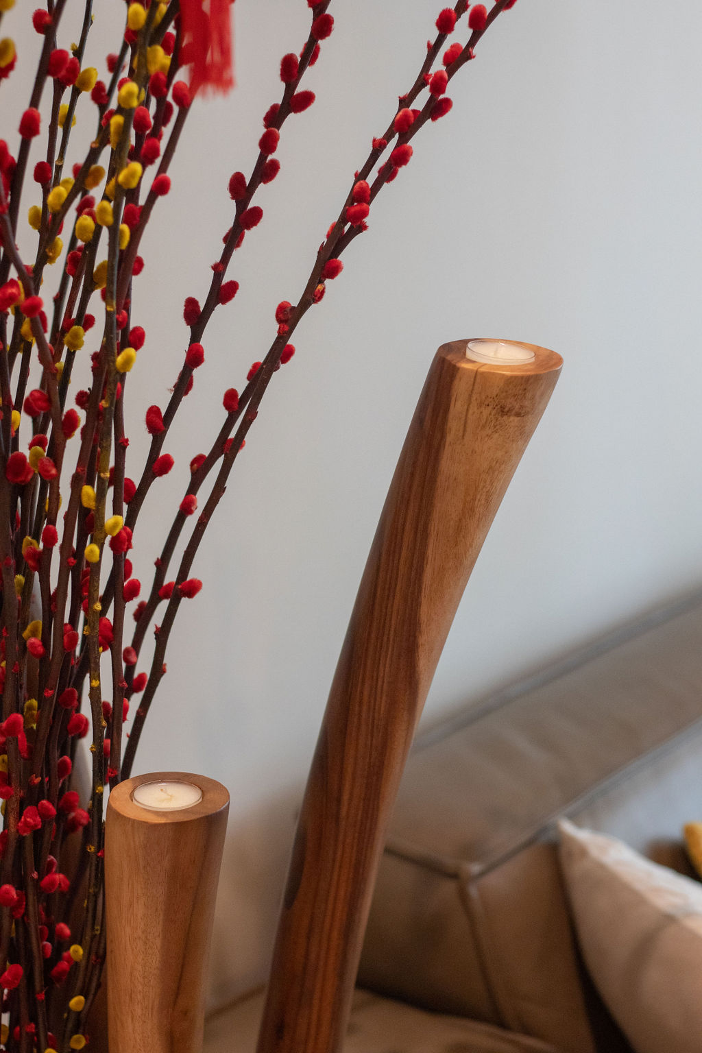Home-Styling Tips: Achieving a cohesive island-living inspired home  - wooden candlestick, red and yellow branches, soft