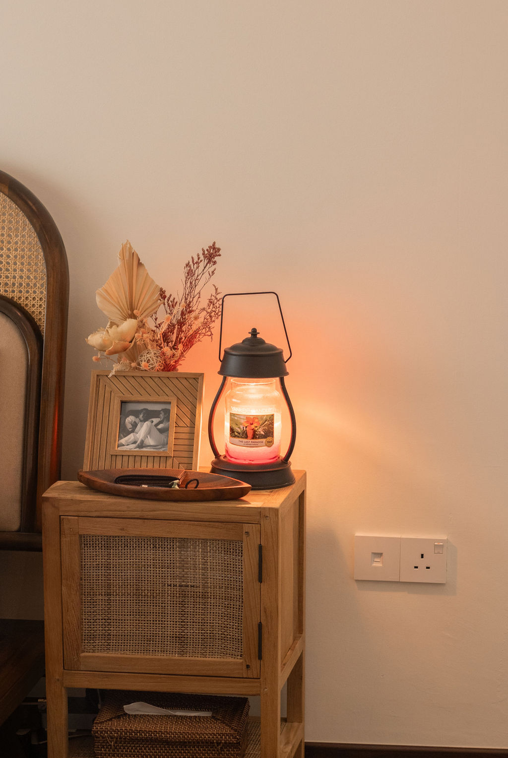 Home-Styling Tips: Achieving a cohesive island-living inspired home  - Wooden side table, lantern, warm light, decorative