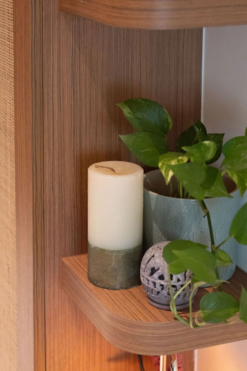 Home-Styling Tips: Achieving a cohesive island-living inspired home  - Wooden shelf, green plant, white candle, textured pot