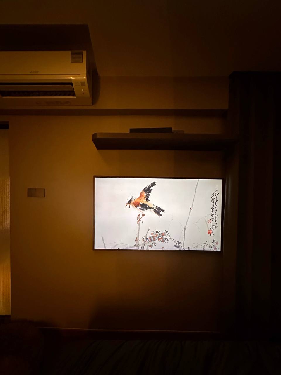 Hotel-inspired Bedroom: Daily Staycation! - Dimly lit room, wall-mounted air conditioner, traditional artwork, bird on