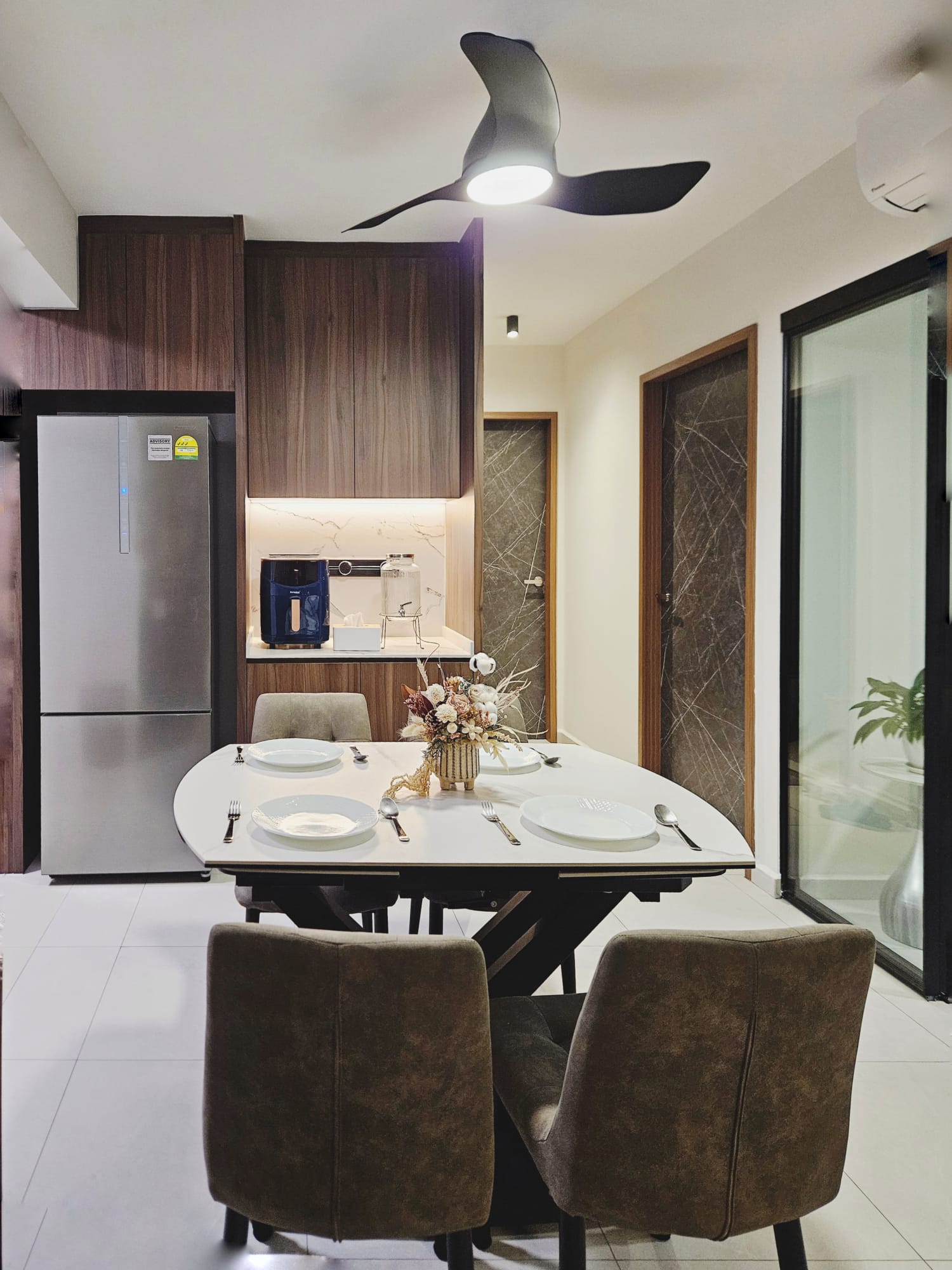 Practicality over aesthetics Dining room - Modern kitchen with sleek stainless steel refrigerator, wooden cabinets, and