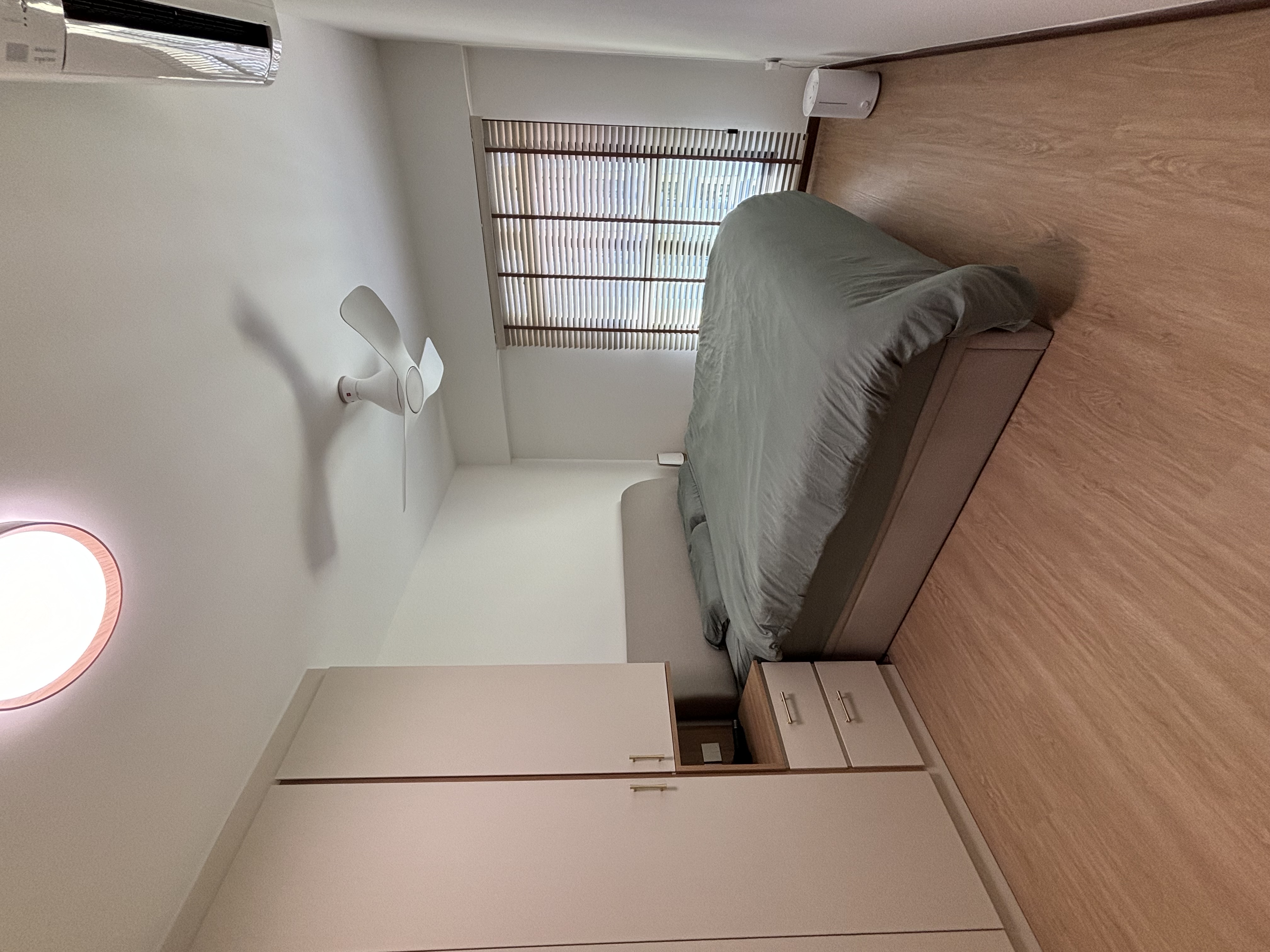 Maxmising walking space in our coastal hues bedroom - Compact bedroom with bed, ceiling fan, air conditioning unit, circular