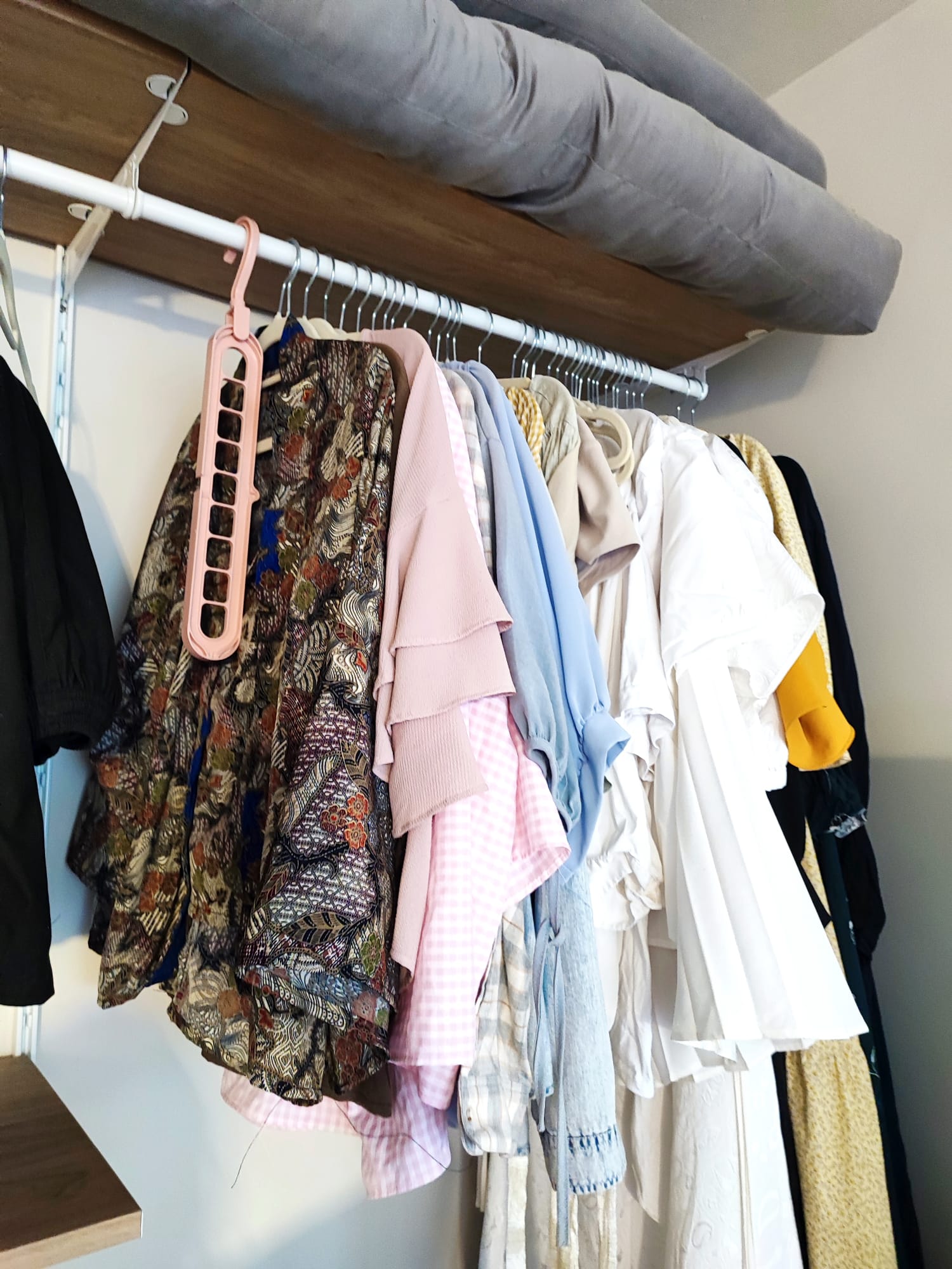 Maximizing flexibility: Minimal cosy bedroom with no built-ins - Patterned blouse, floral jacket, pink sweater, checkered