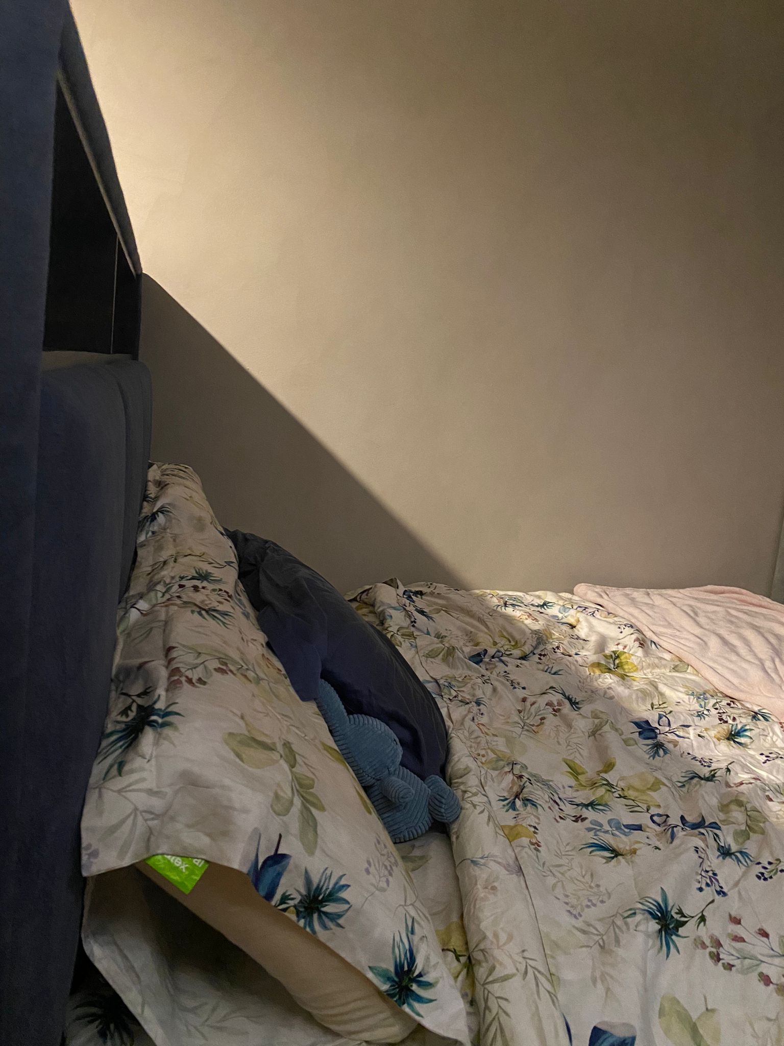 Integrating sleep and play for a space constrained 4-room BTO - Floral-patterned bedspread, blue plush toy, dark blue pillow